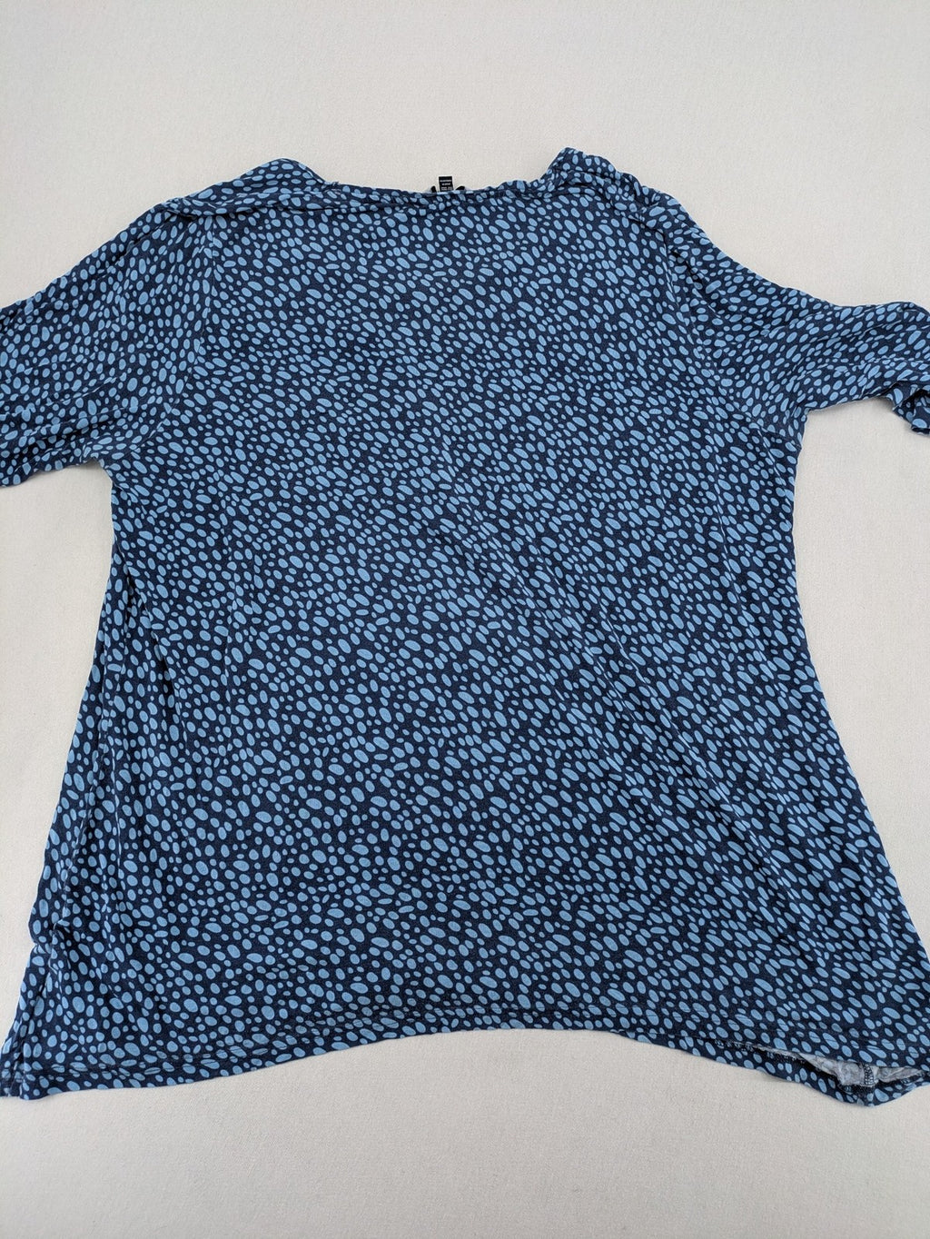 Ulla Popken blue tunic top with light blue polka dots and A-line cut.