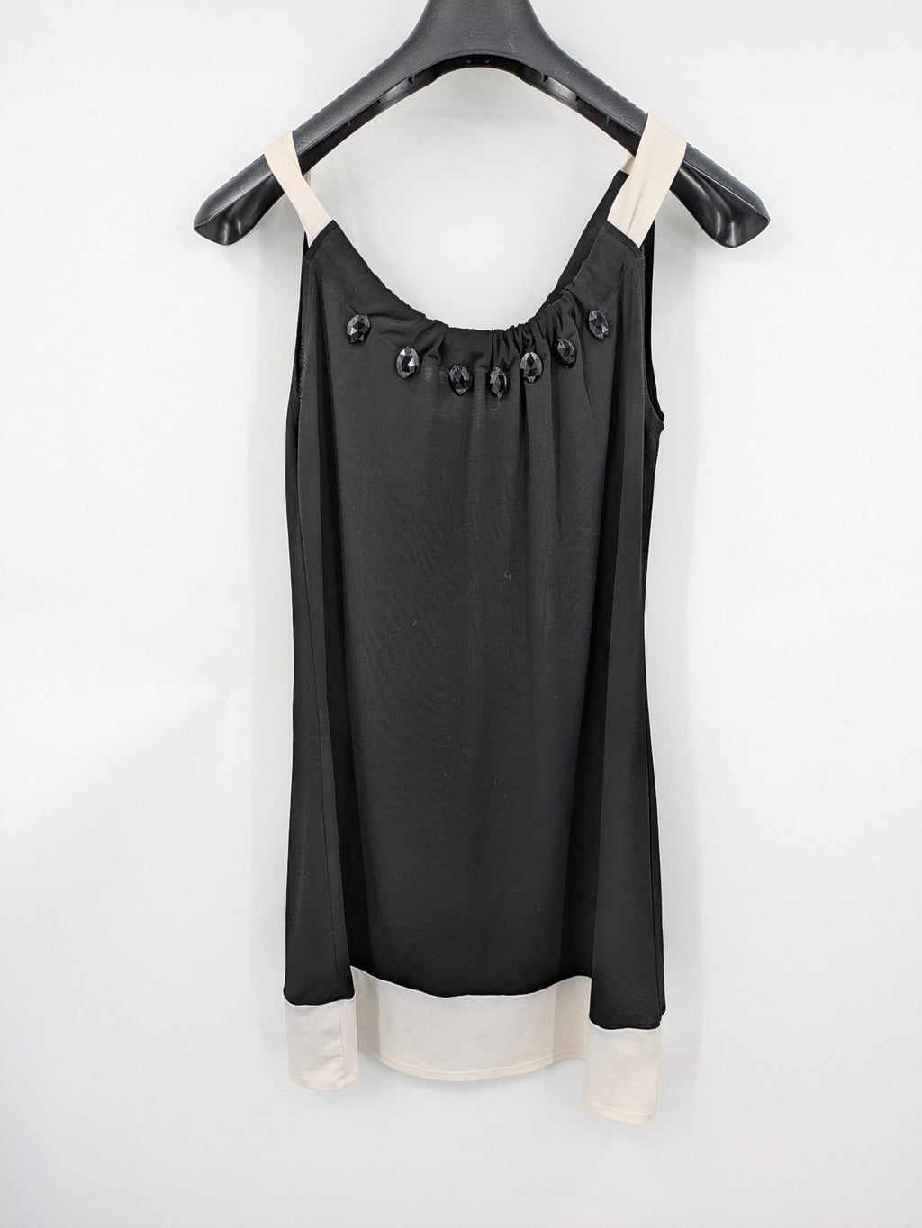 En Focus Studio beige and black top, sleeveless with beaded neckline and tie detail.