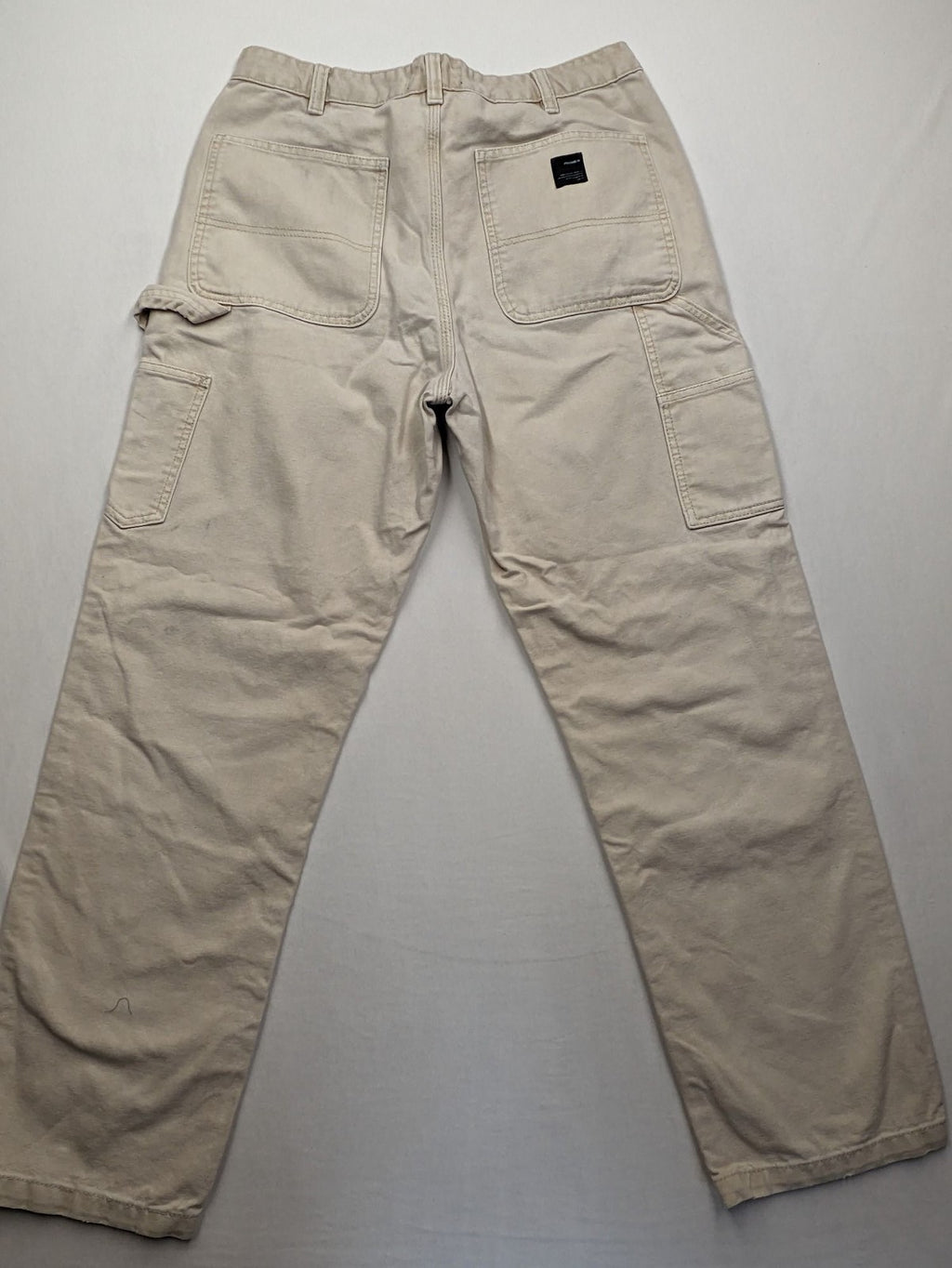 Pull&Bear beige carpenter pants with classic zipper, belt loops, and durable cotton material.