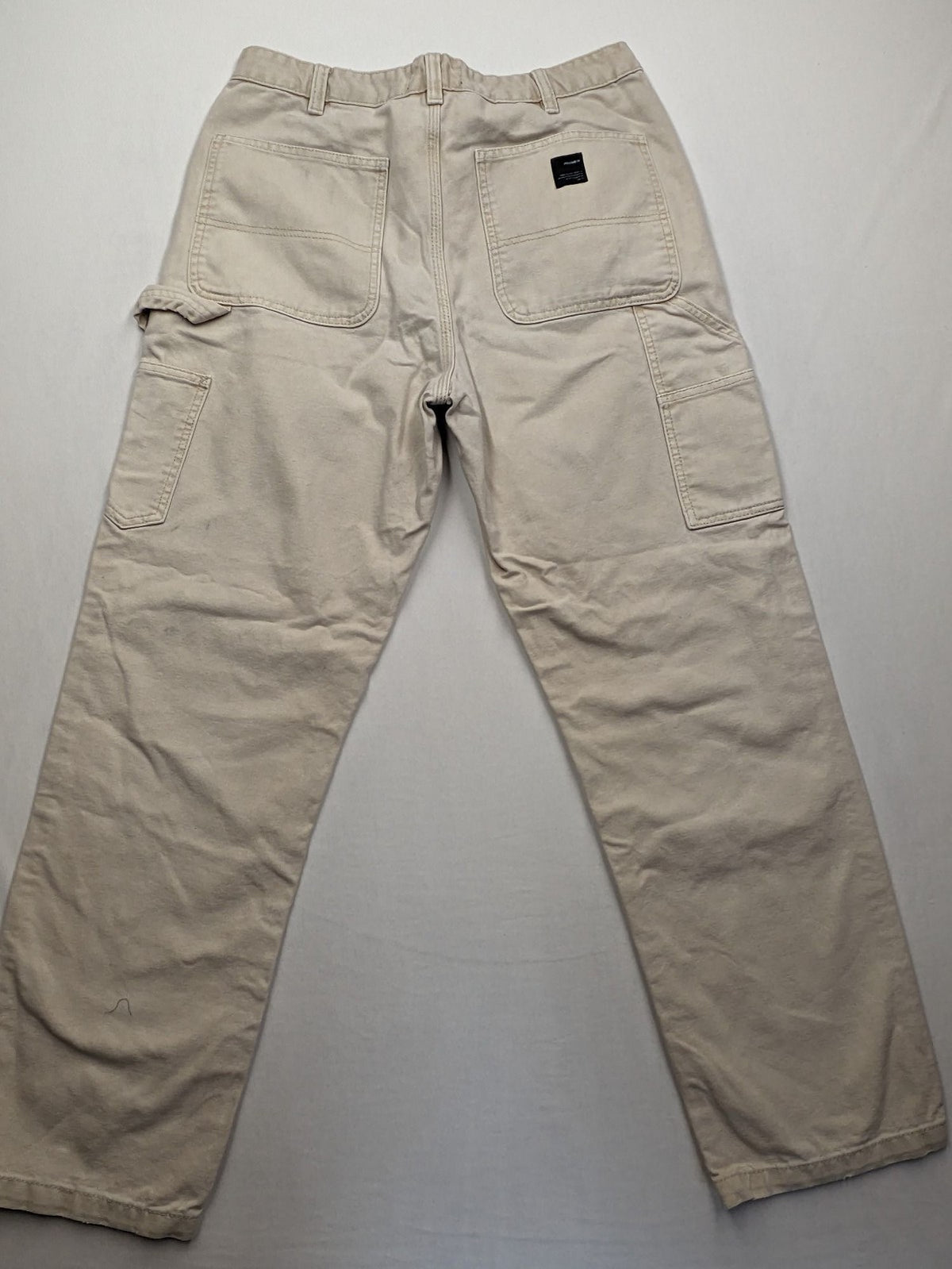 Pull&Bear beige carpenter pants with classic zipper, belt loops, and durable cotton material.