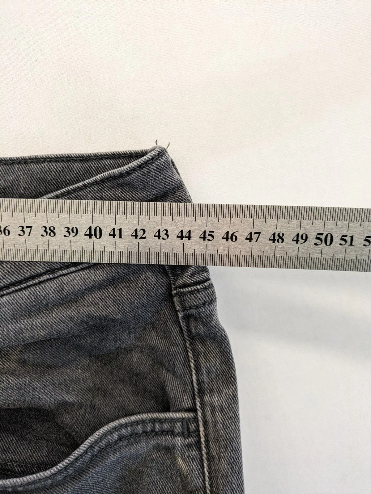 COS grey straight jeans with classic 5-pocket style and washed denim texture.