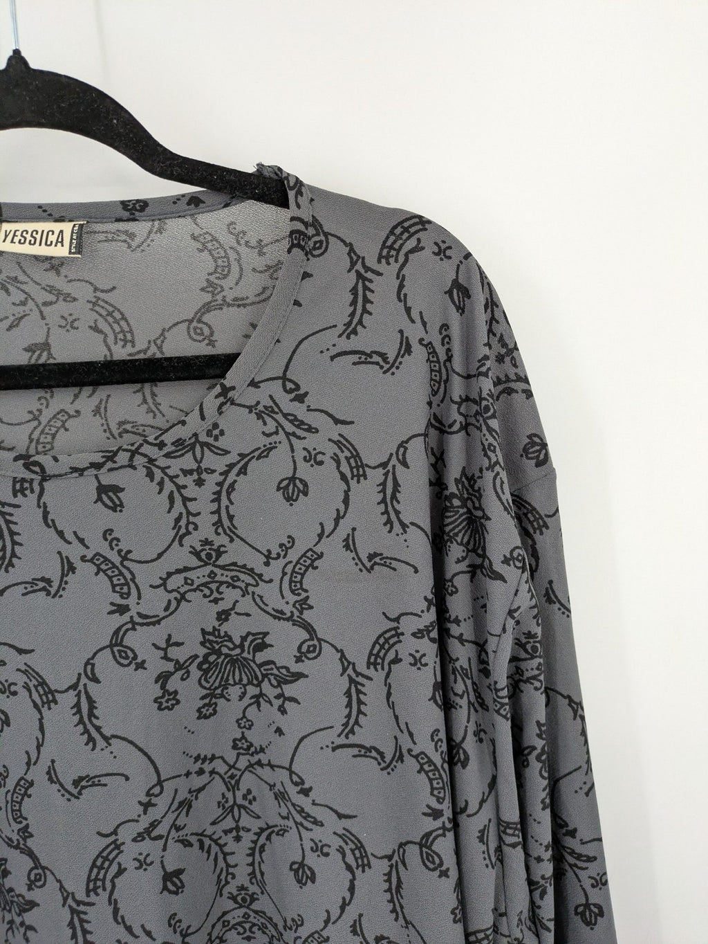 Yessica grey black floral pattern tunic top with round neckline and long sleeves.