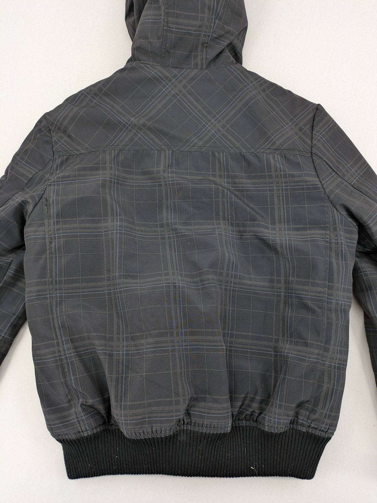 Jack & Jones grey checkered winter jacket with hood, quilted lining, and zip closure.