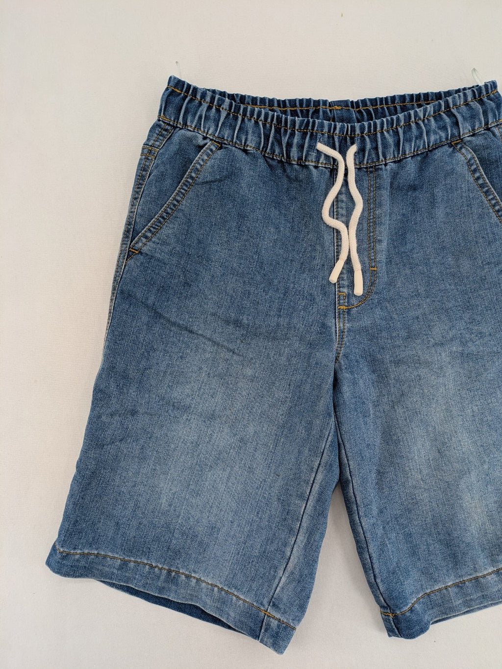 C&A blue denim shorts with elastic waistband and decorative drawstring, classic style.