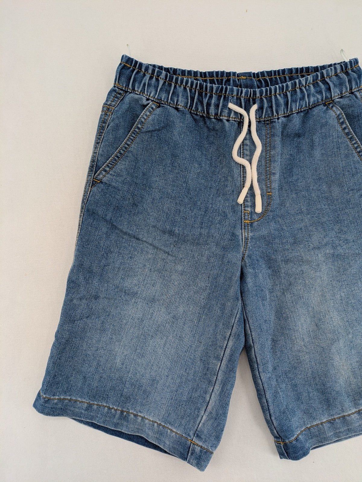 C&A blue denim shorts with elastic waistband and decorative drawstring, classic style.