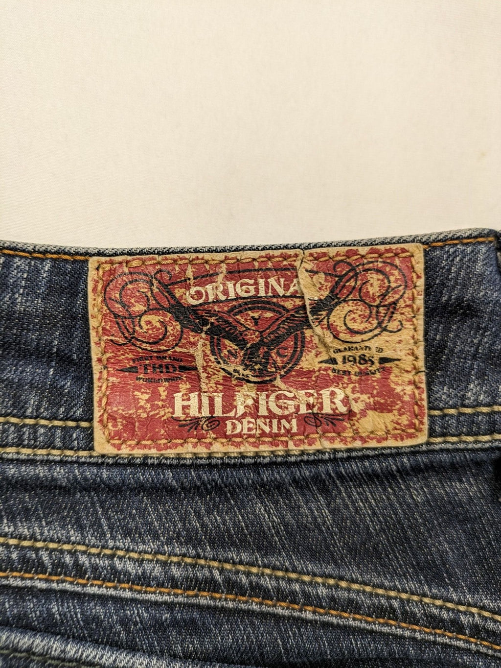 Tommy Hilfiger Denim blue straight jeans with low rise and slight used effects.