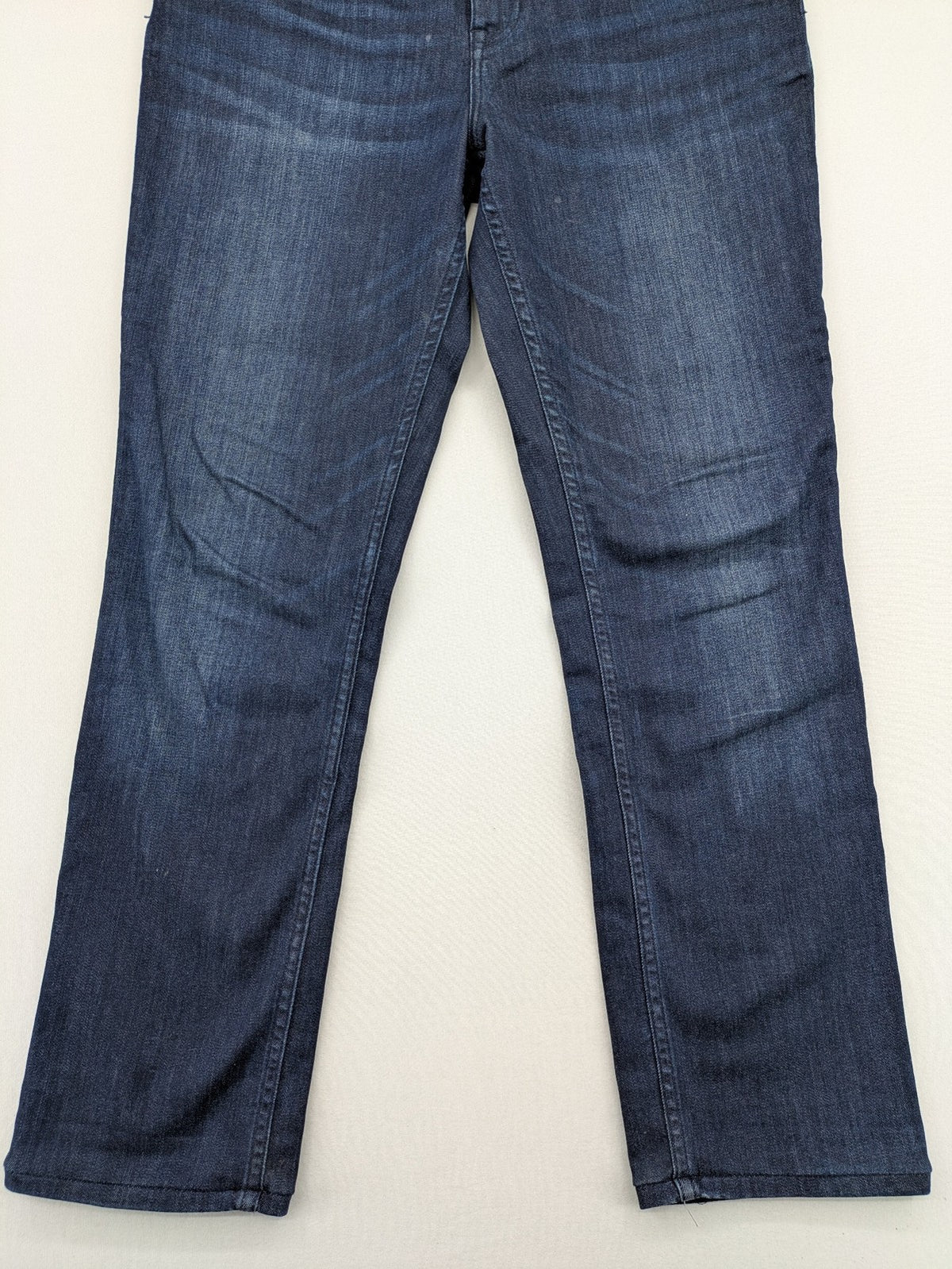 Tommy Hilfiger blue straight jeans with iconic logo and dark wash denim finish.
