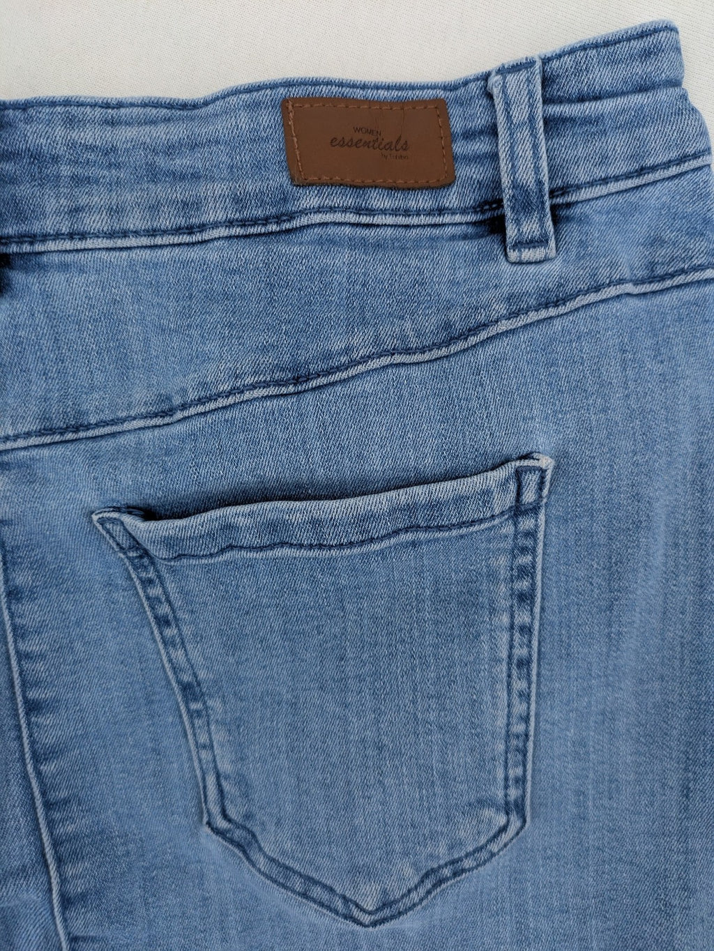 Tchibo blue A-line denim skirt classic five-pocket design with zipper and button closure.