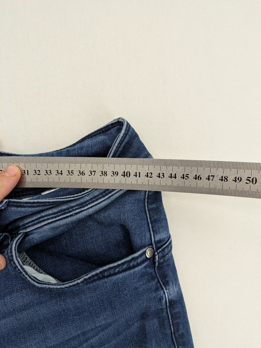 Tom Tailor blue skinny jeans with classic 5-pocket design and double button closure.