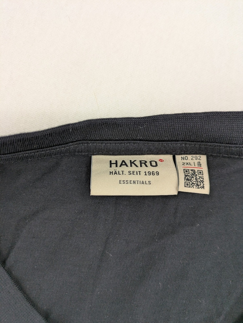 HAKRO blue and grey T-shirt with embroidered TAC Training logo on chest.