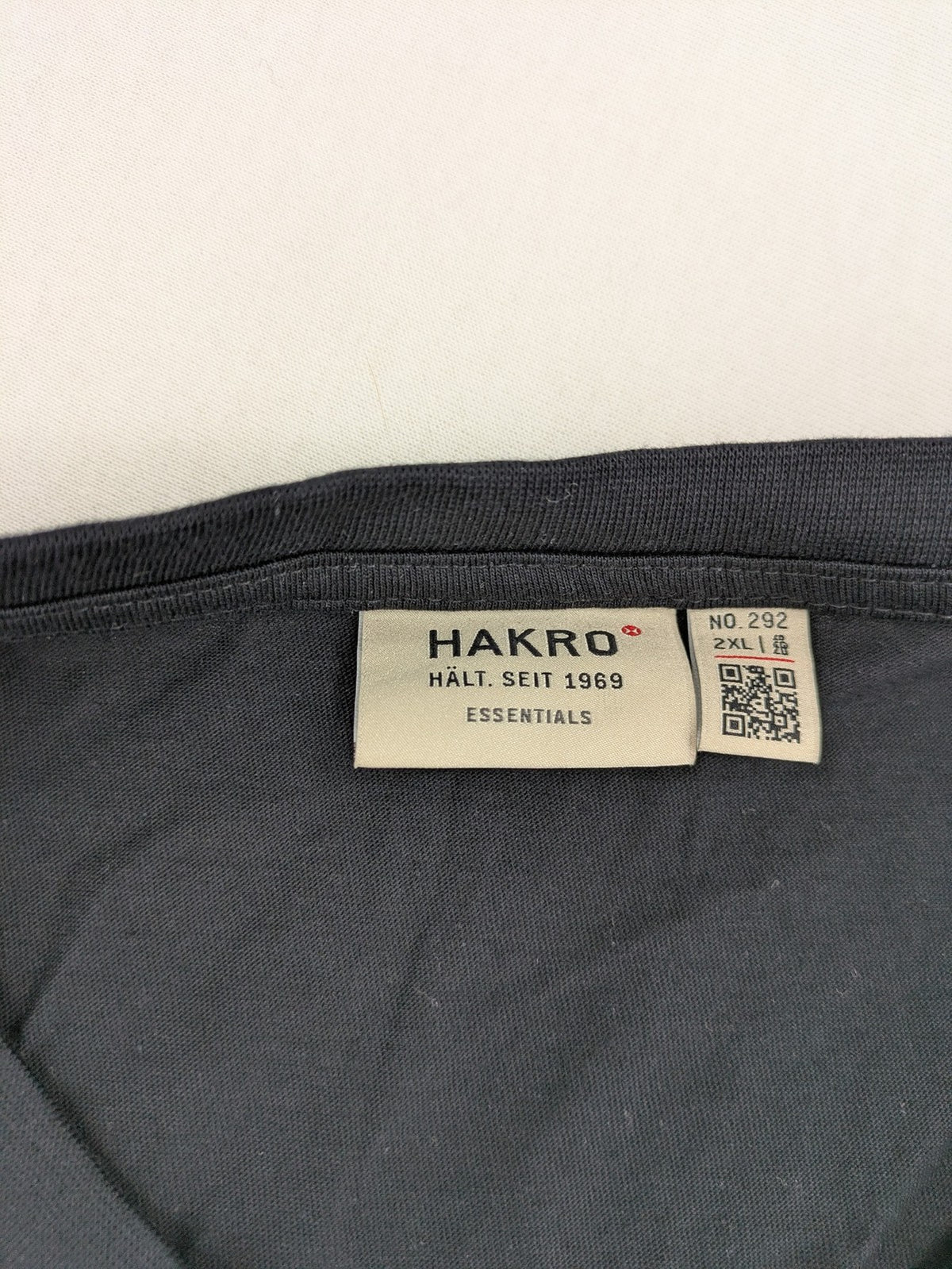 HAKRO blue and grey T-shirt with embroidered TAC Training logo on chest.