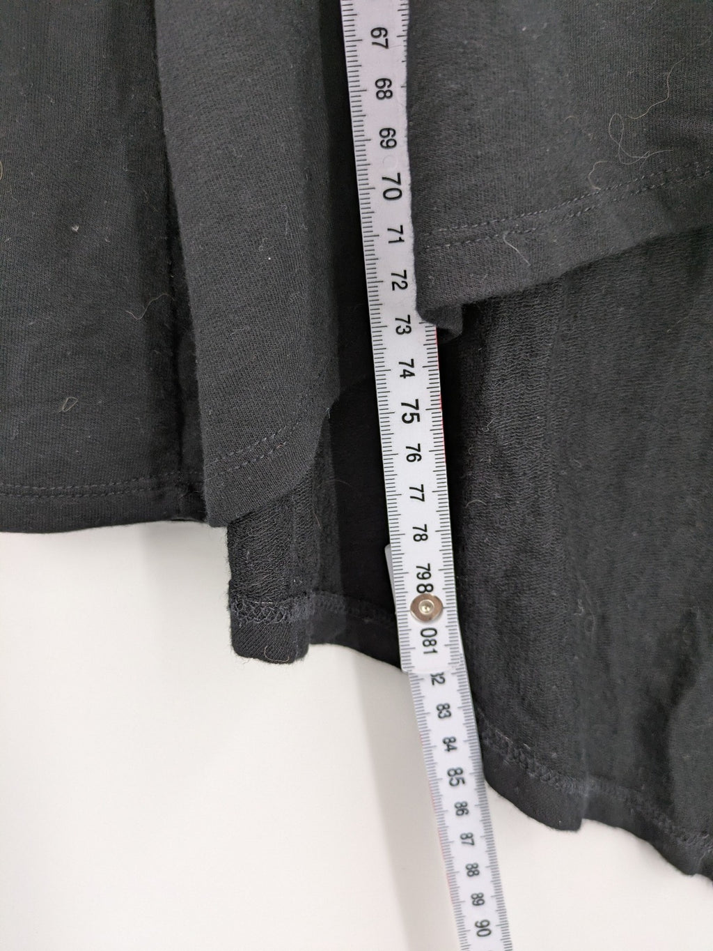 Cupio black long sleeve tunic with side button placket and high-low hem.