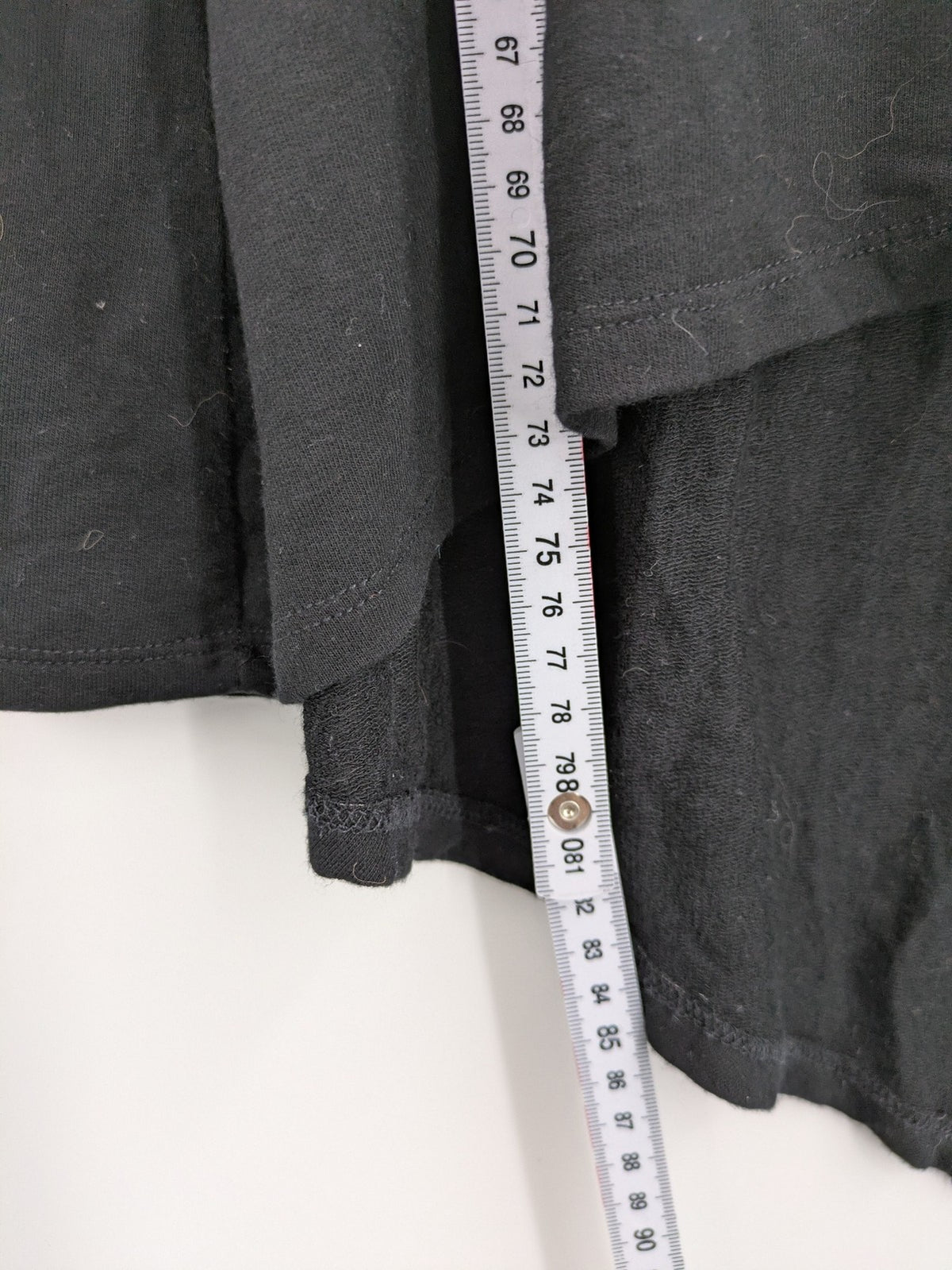 Cupio black long sleeve tunic with side button placket and high-low hem.