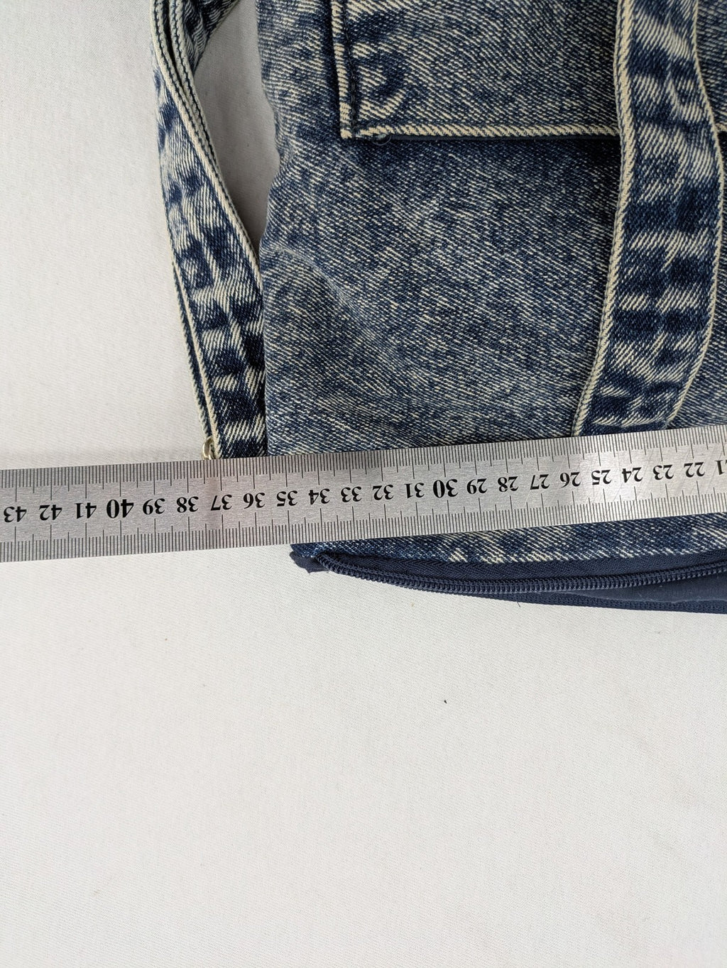 Clockhouse blue acid wash denim tote bag with adjustable shoulder strap and classic handles.