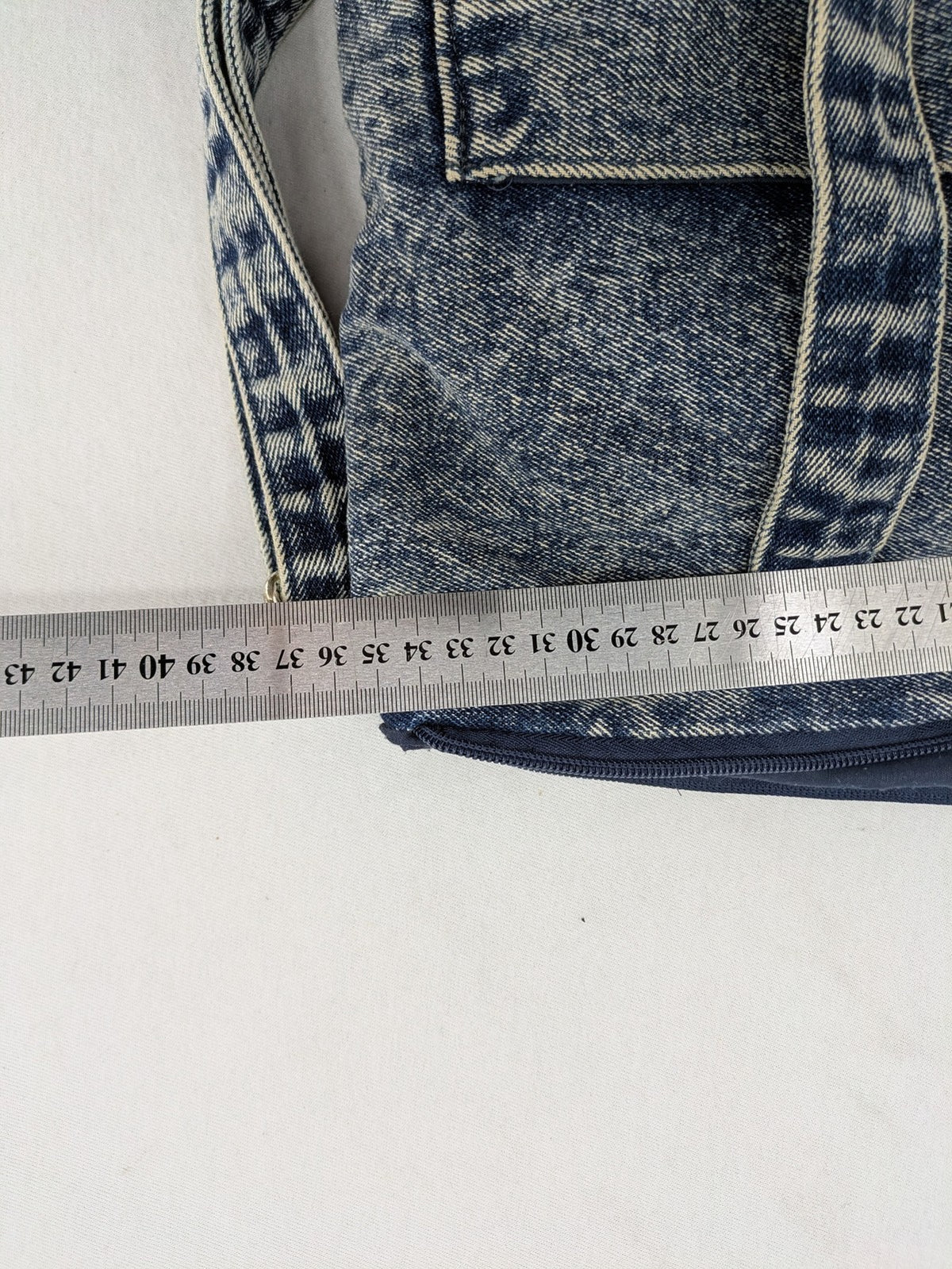 Clockhouse blue acid wash denim tote bag with adjustable shoulder strap and classic handles.