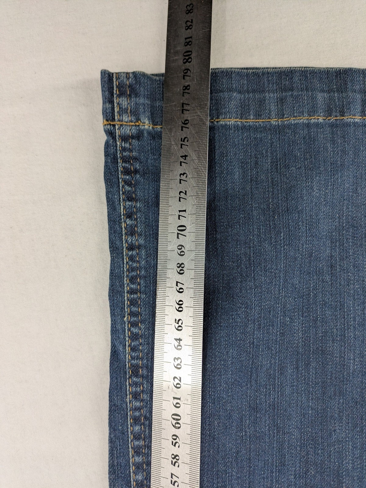 Rosner blue wide leg jeans with colorful embroidery on back pockets.
