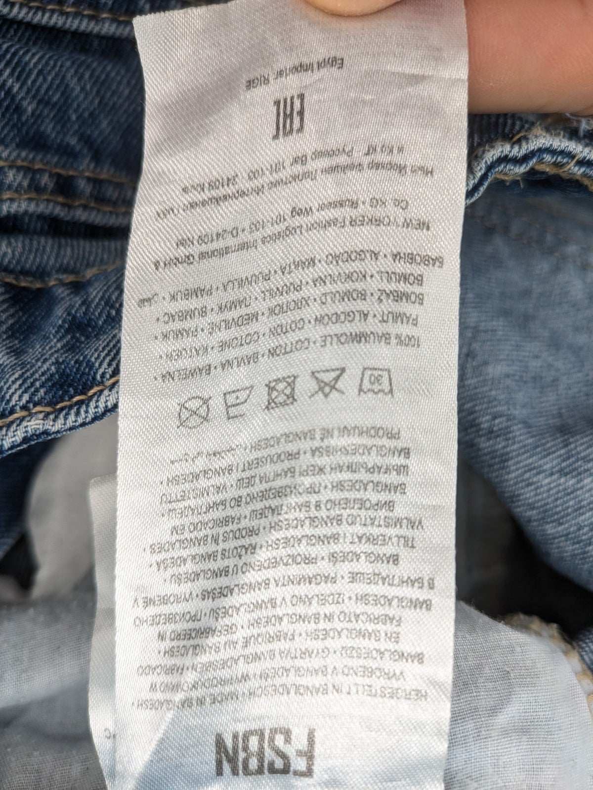 FSBN blue straight jeans with distressed knee rips and classic button fly.