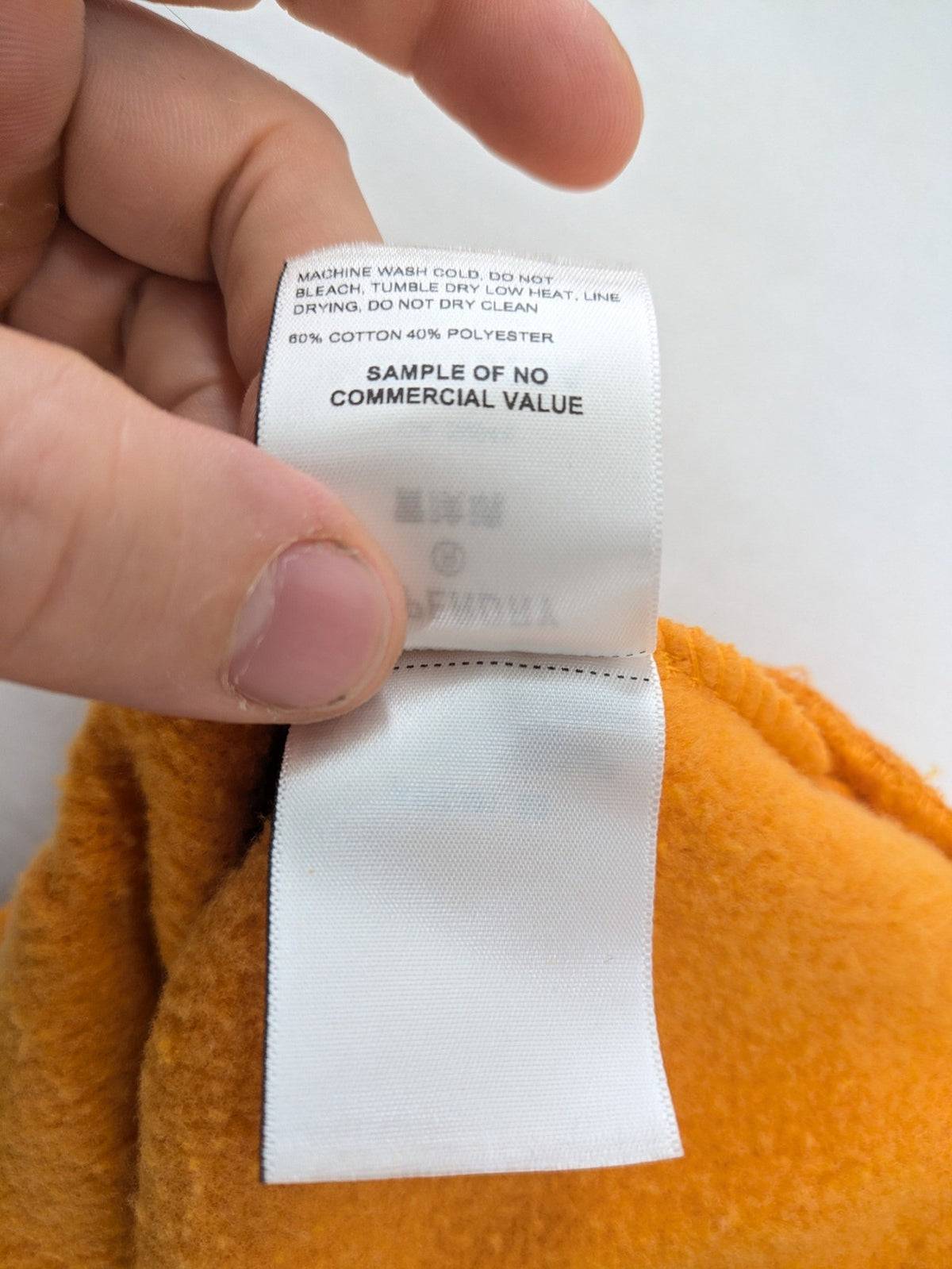 Superdry orange turtle neck jumper with textured logo patch and number 7 detail.