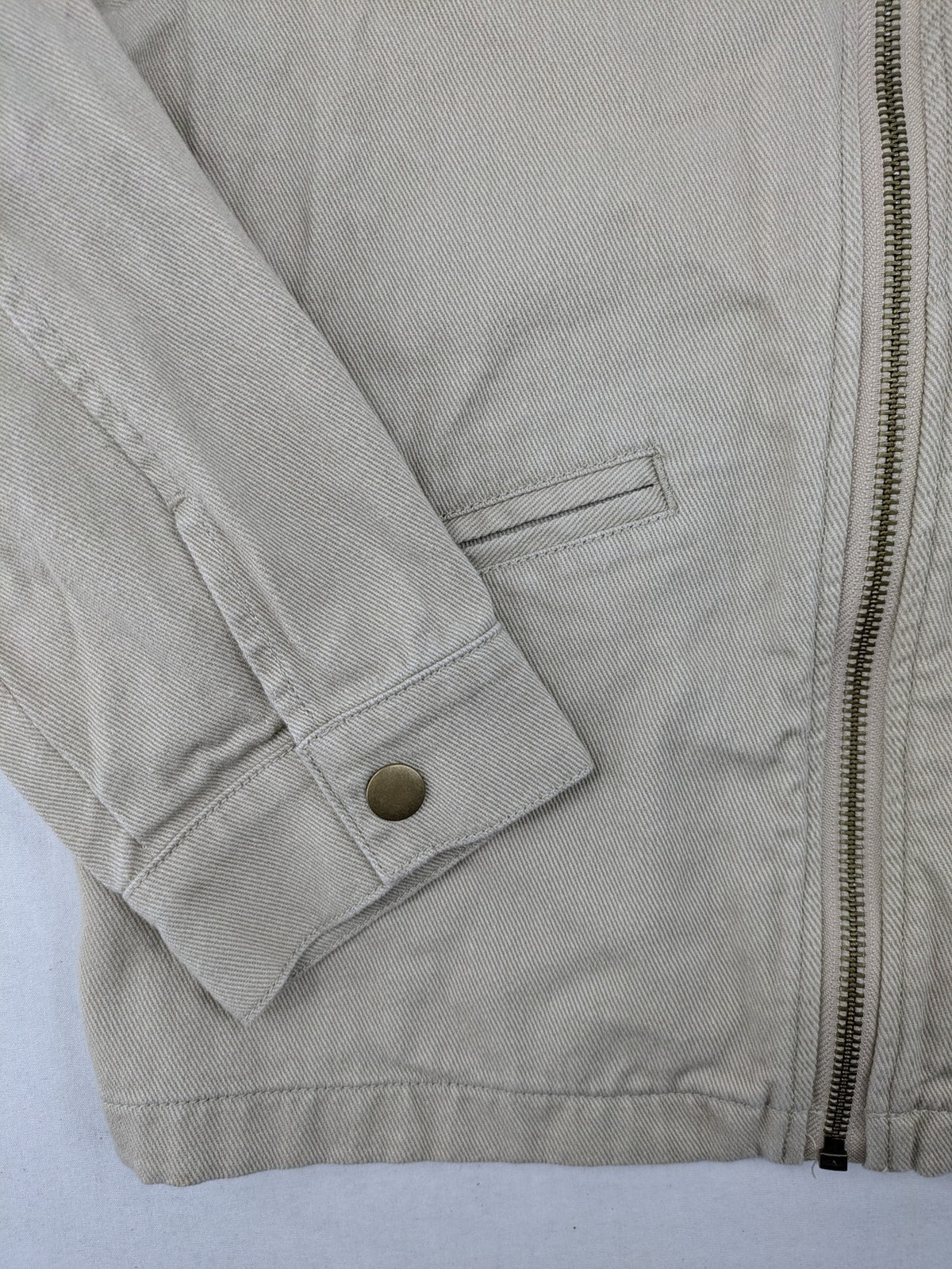 H&M beige twill coat with full zip, classic collar, and practical pockets.