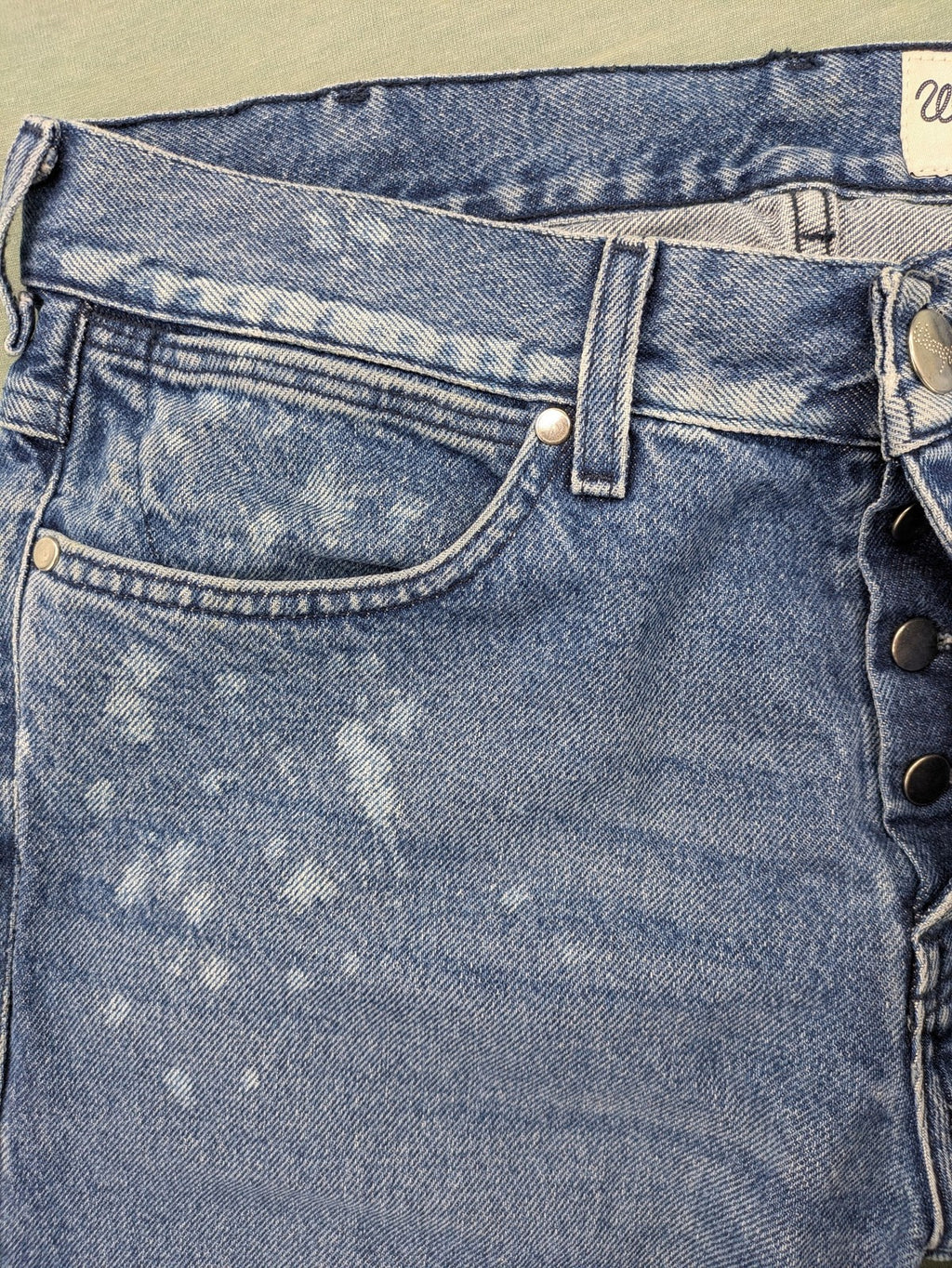 Wrangler blue straight jeans with button fly and classic 5-pocket design.