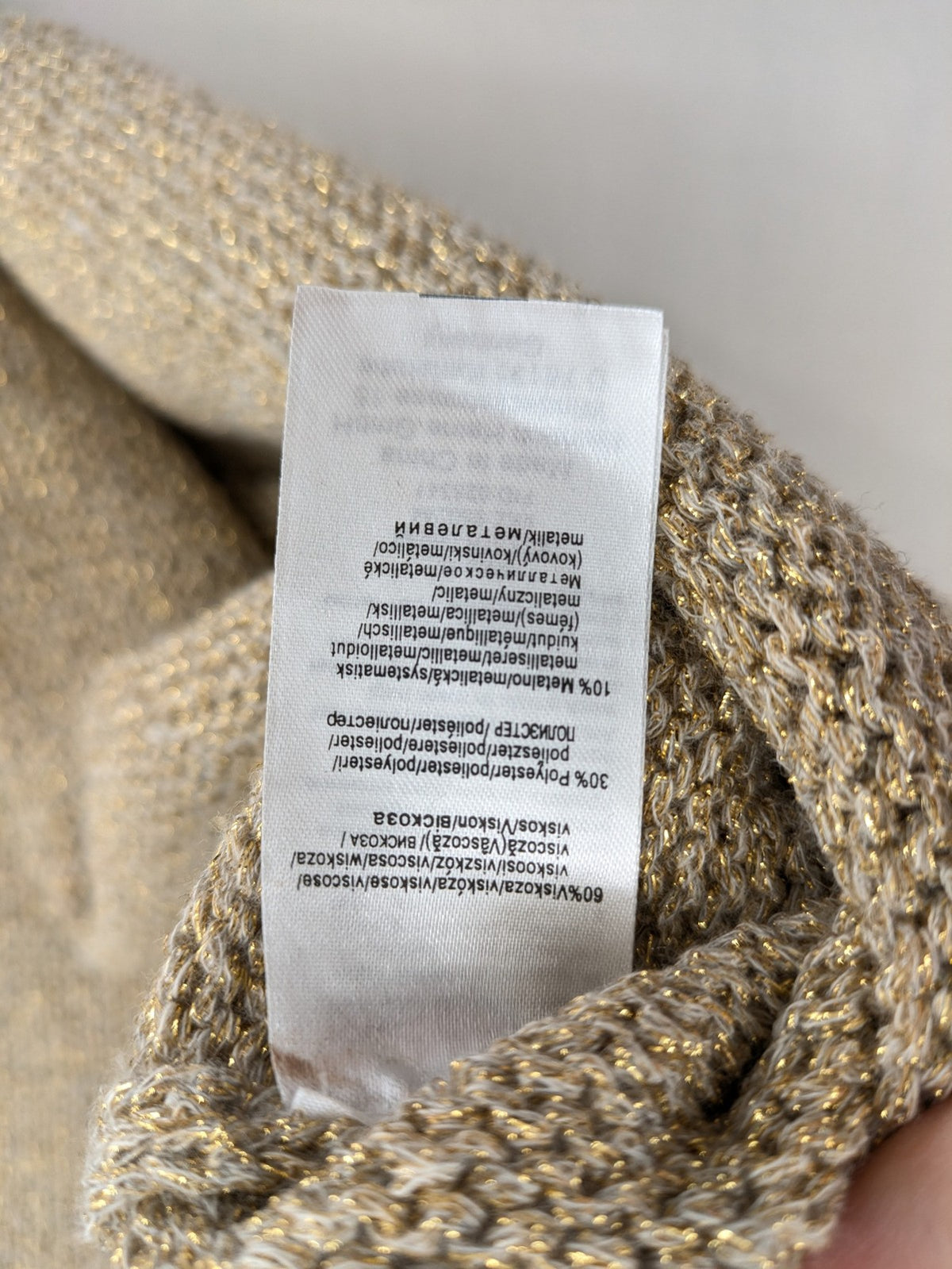 Rick Cardona beige turtle neck jumper with gold metallic thread and balloon sleeves.