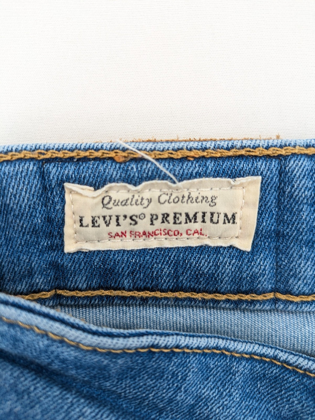 Levi's blue skinny jeans with raw hem, classic five-pocket design, and zip fly.