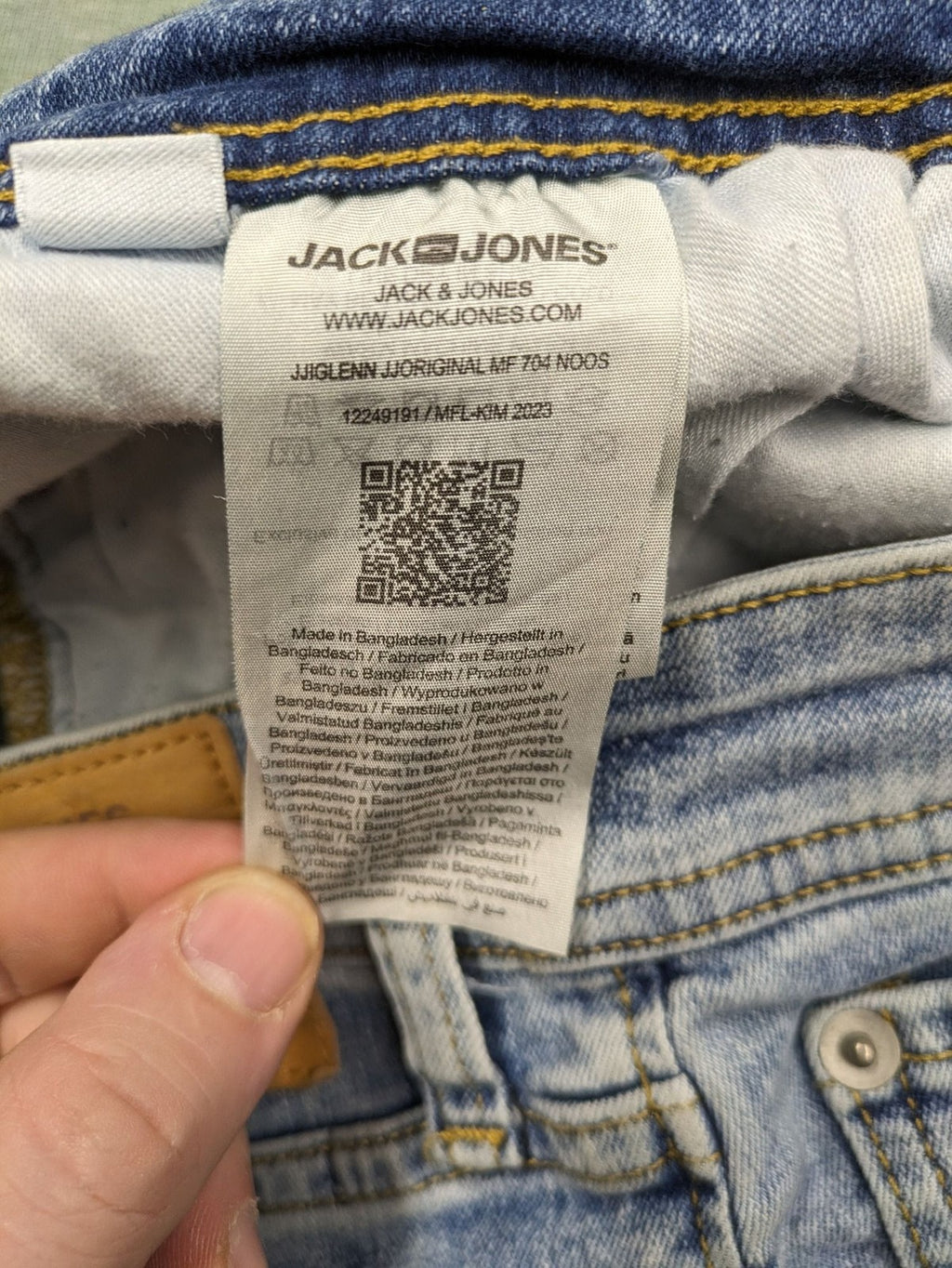 Jack & Jones blue slim fit jeans with button fly and light wash denim texture.