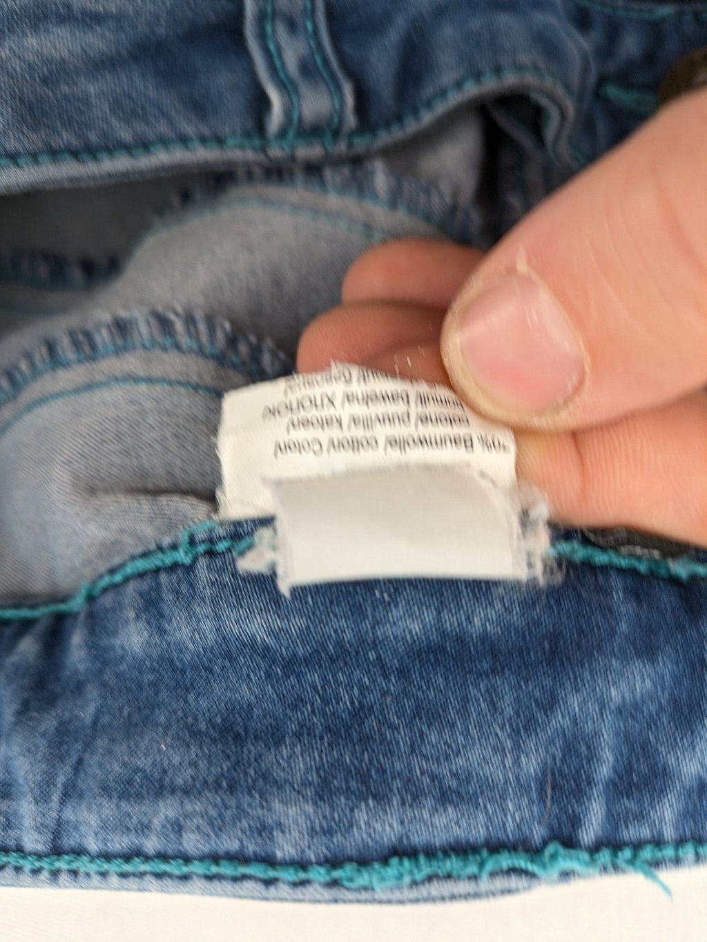 Rainbow blue straight jeans jogger style with button fly and contrasting turquoise stitching.