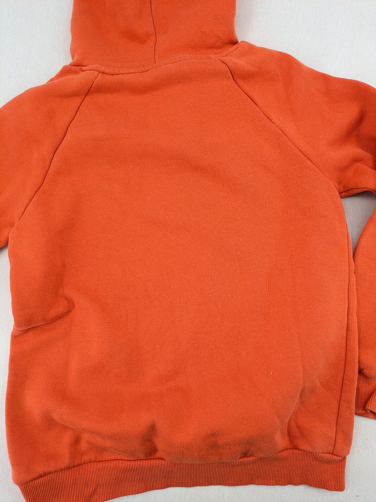 Ginatricot orange hoodie with embroidered winking eye detail, soft material, classic fit.