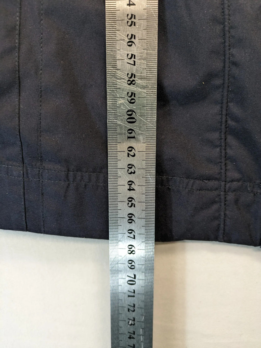 WPF grey outdoor jacket with red lining, zip closure, and hood.