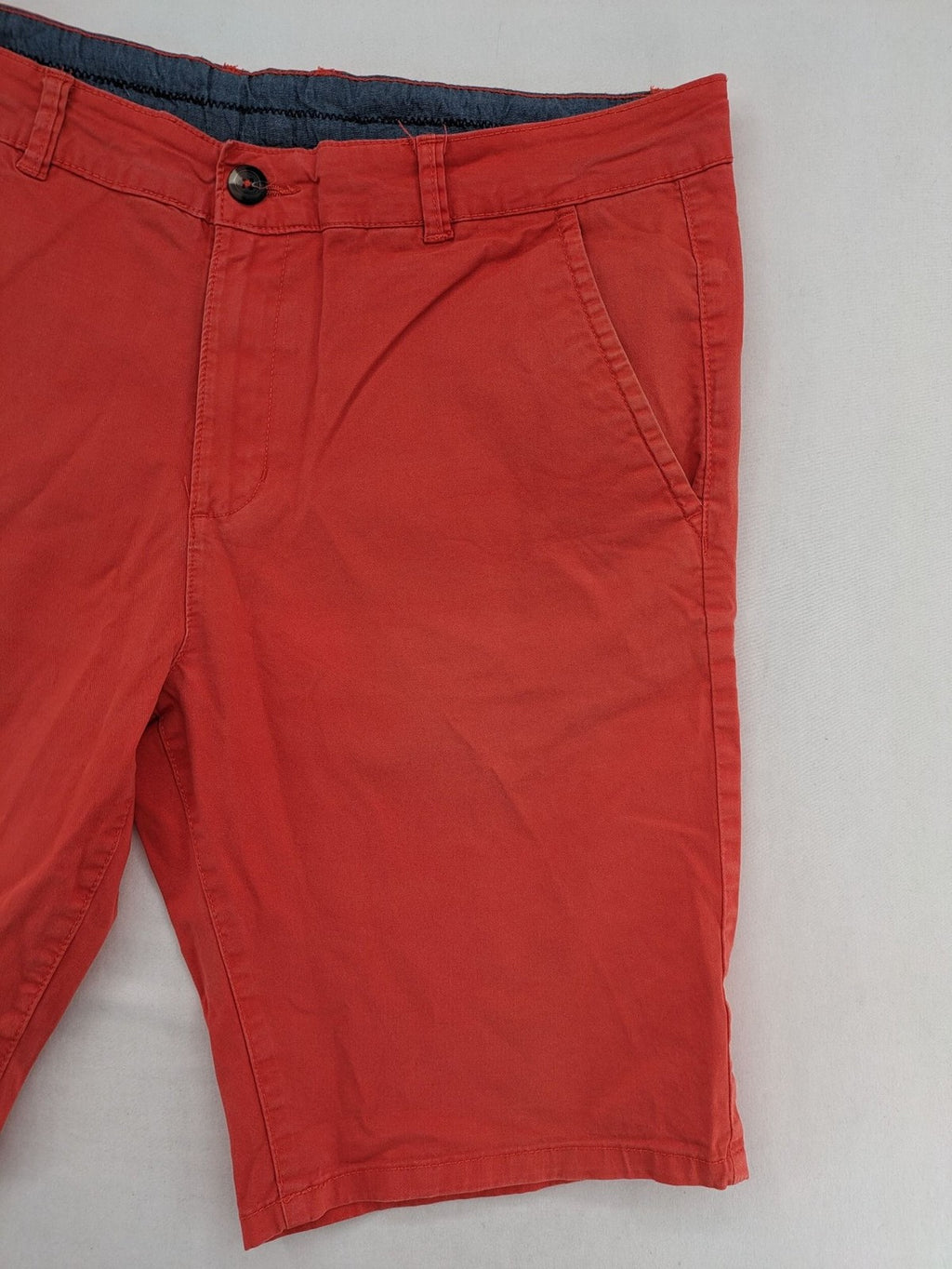 Chino orange shorts flat front with Est. 1921 label and comfortable fit.