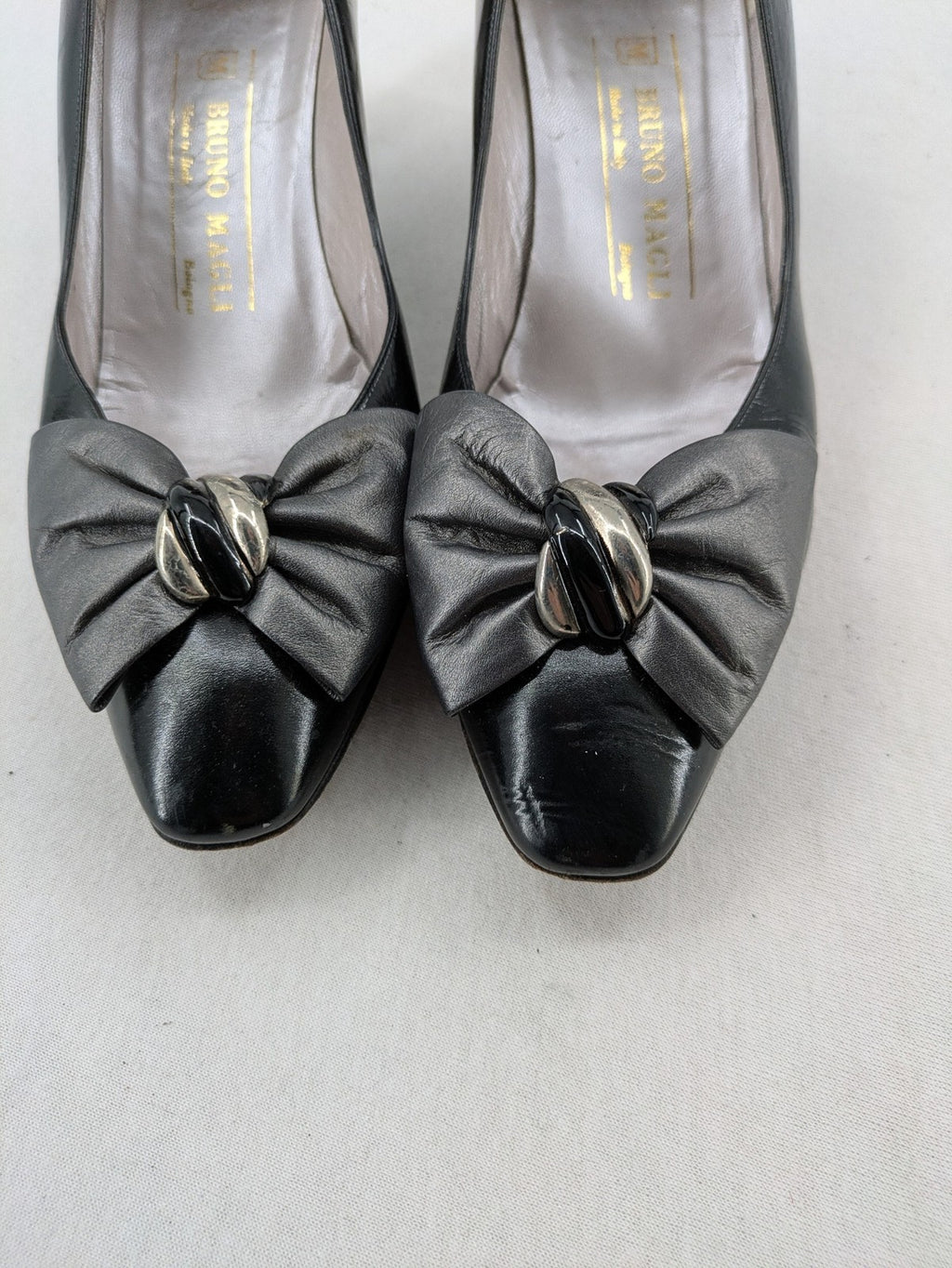 Bruno Magli black high heels leather with grey bow detail and classic silhouette.