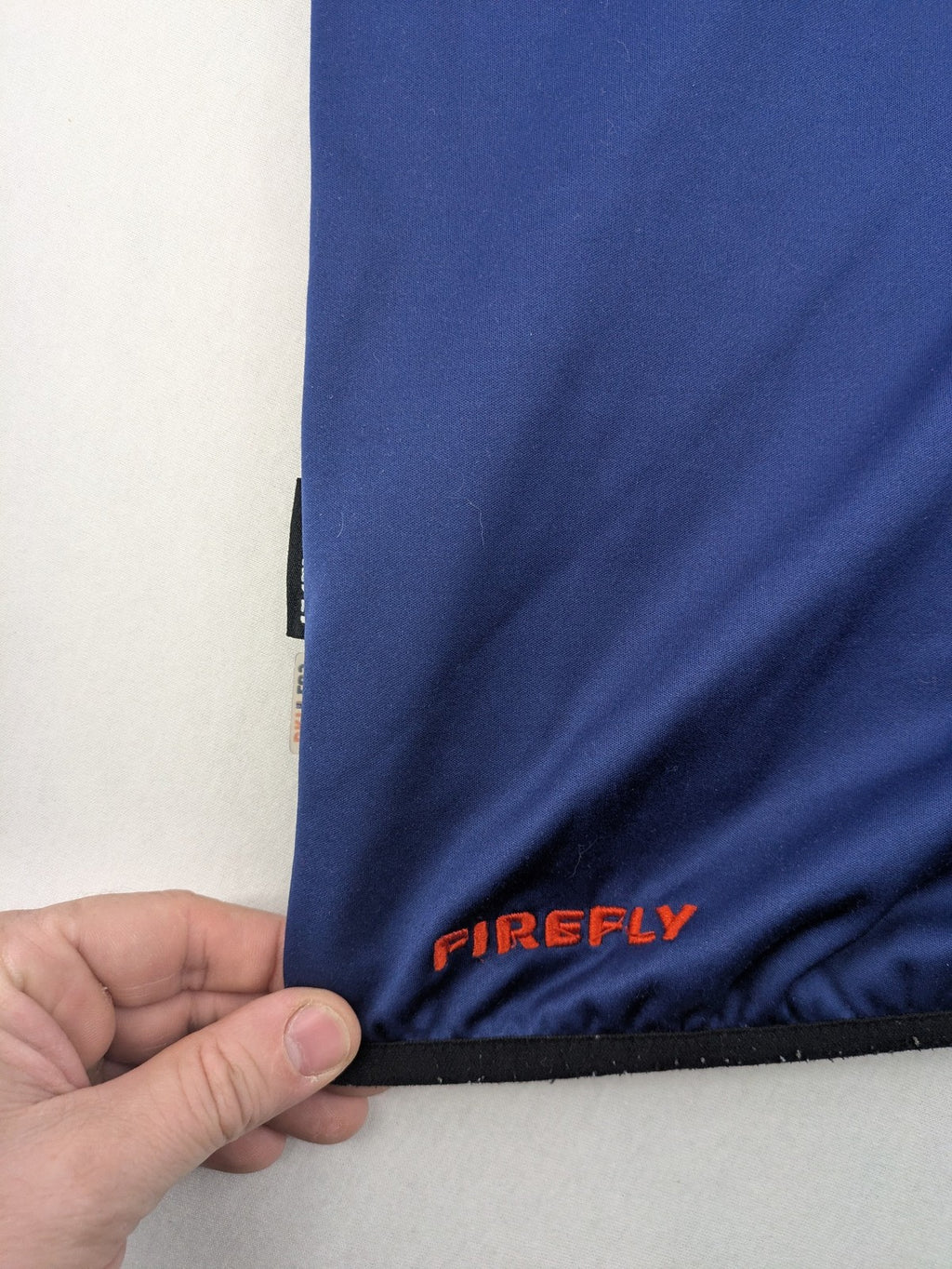 Firefly blue softshell jacket with adjustable hood and prominent chest logo.