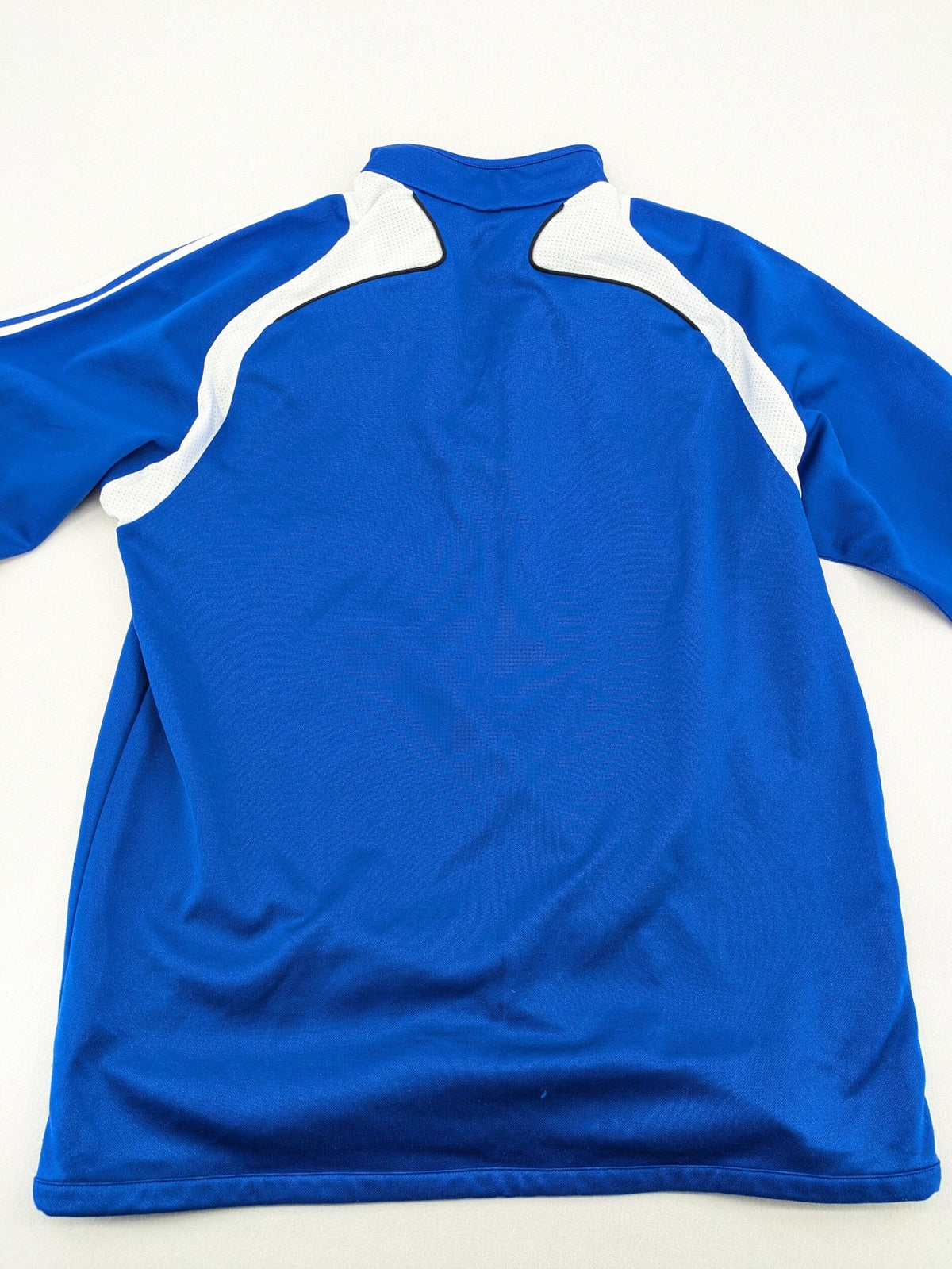 Adidas blue long sleeve top with white three stripes and 1/4 zip collar.