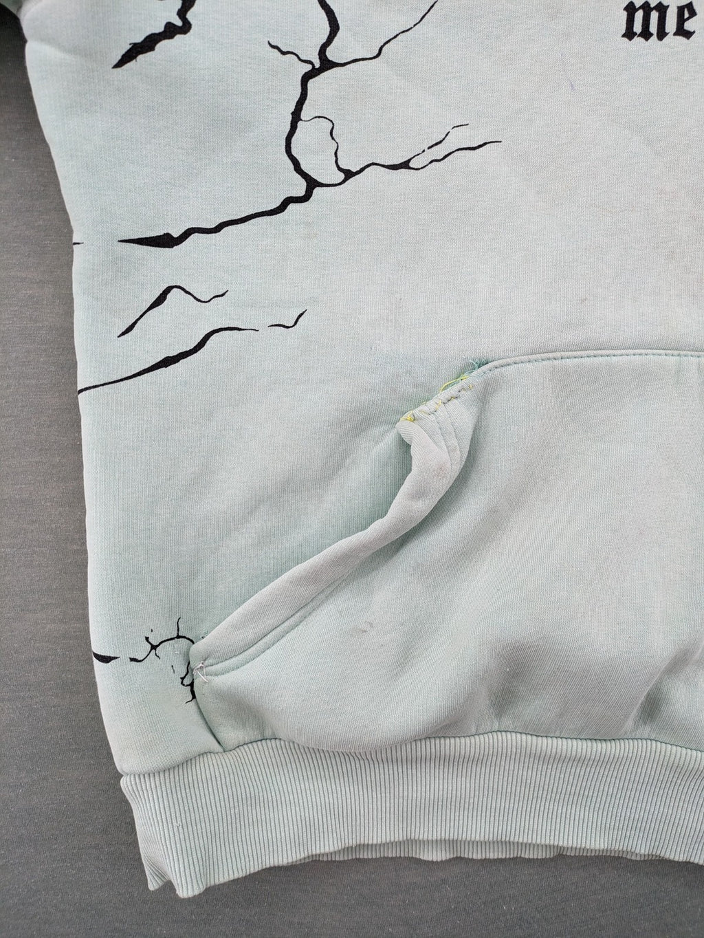 Tupac black and green zip-through hoodie with "Only God Can Judge Me" front print and angel wings graphic.