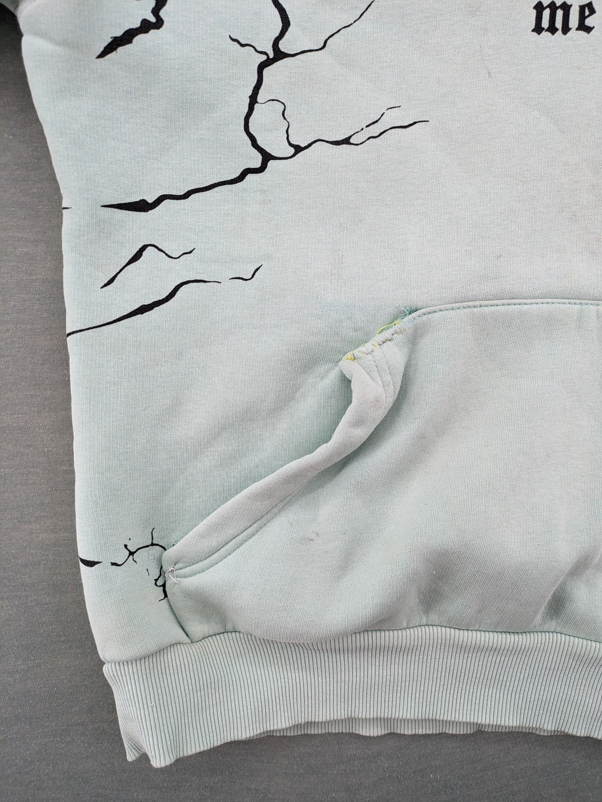 Tupac black and green zip-through hoodie with "Only God Can Judge Me" front print and angel wings graphic.