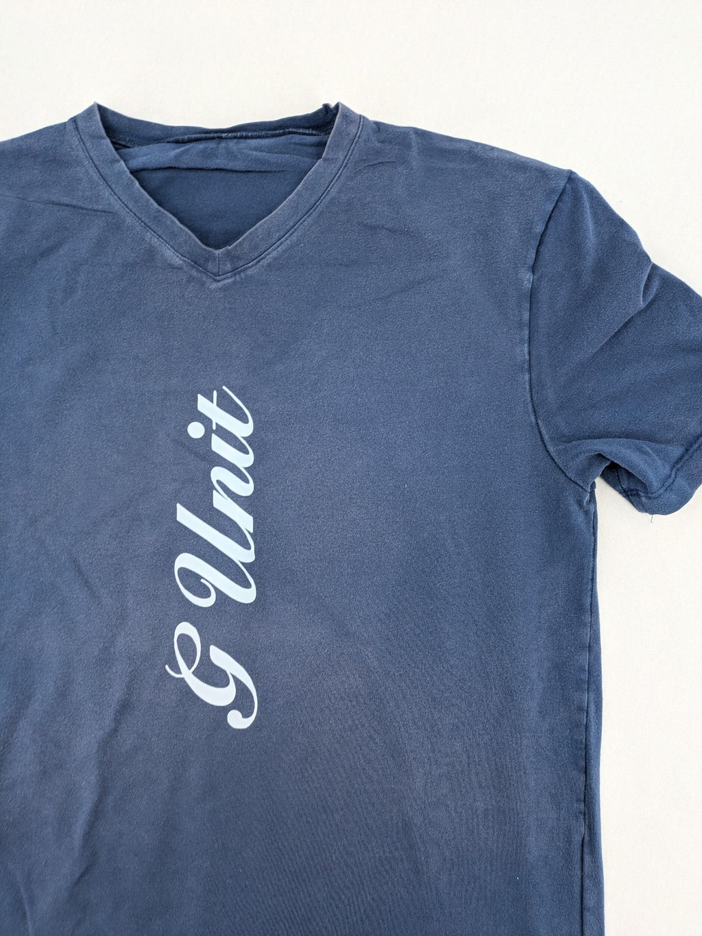 G-Unit navy vintage T-shirt with vertical logo print and V-neck design.