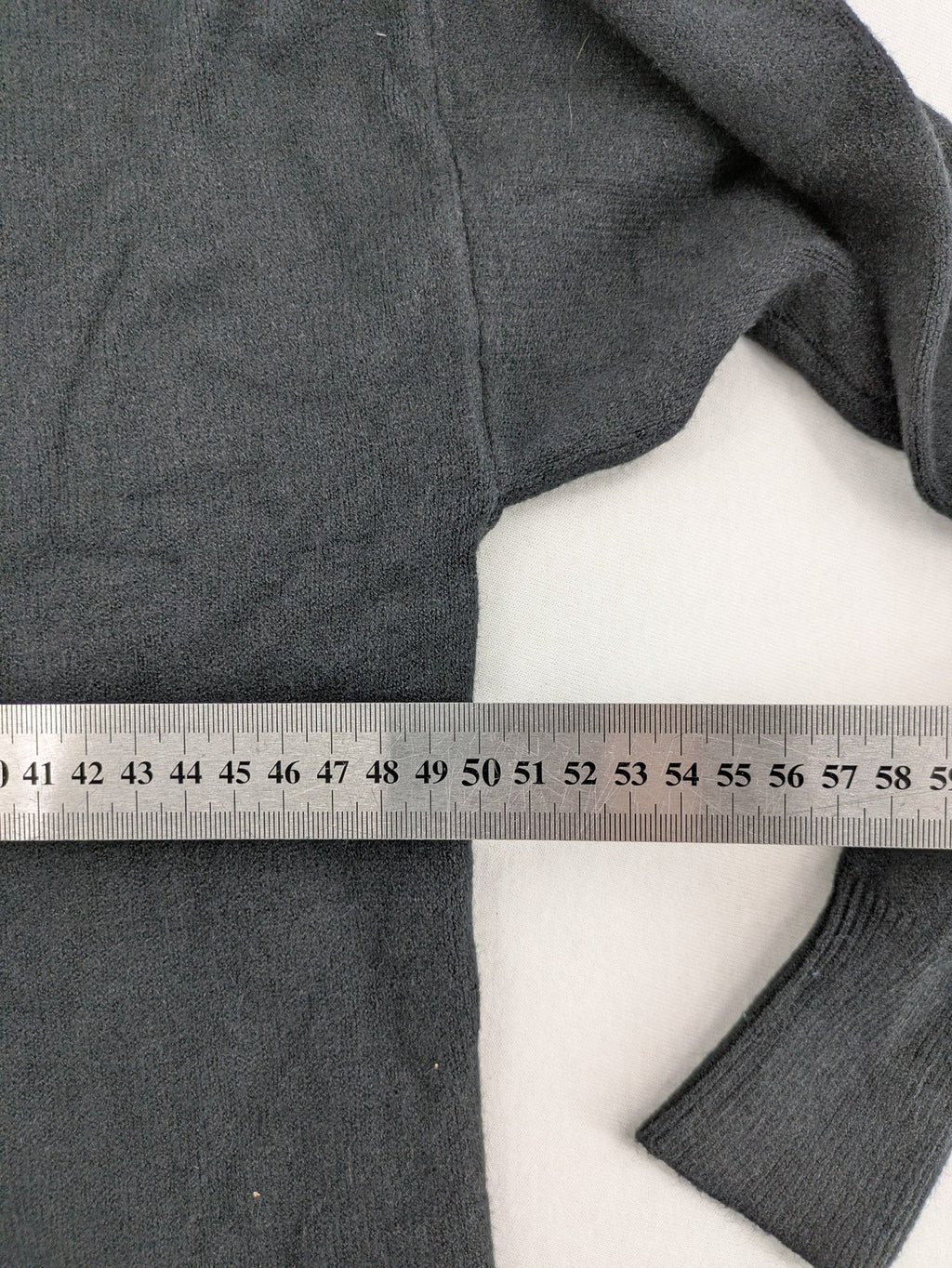 M/L grey hoodie with playful pom-poms and soft viscose blend material.