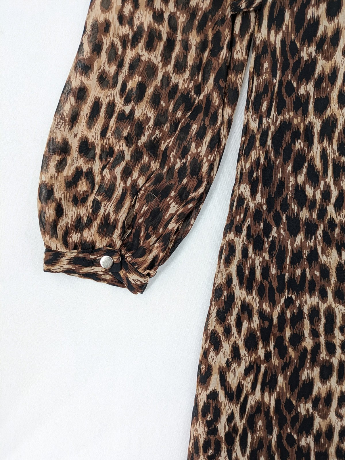 Atmosphere beige leopard print dress with sheer chiffon sleeves and buttoned cuffs.