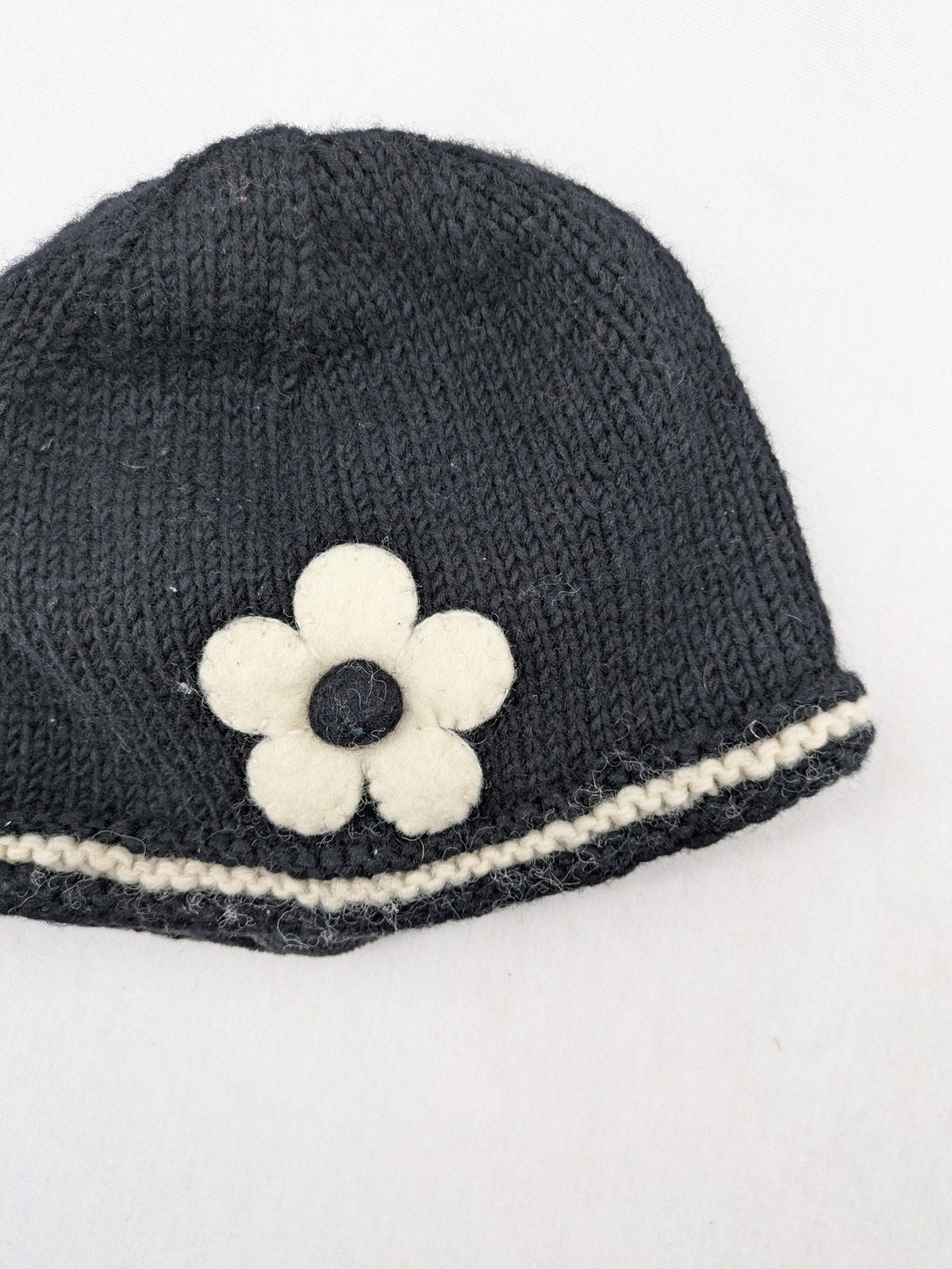 Fischers Textil multi beanie hand-knitted wool with fleece lining and floral appliqué.