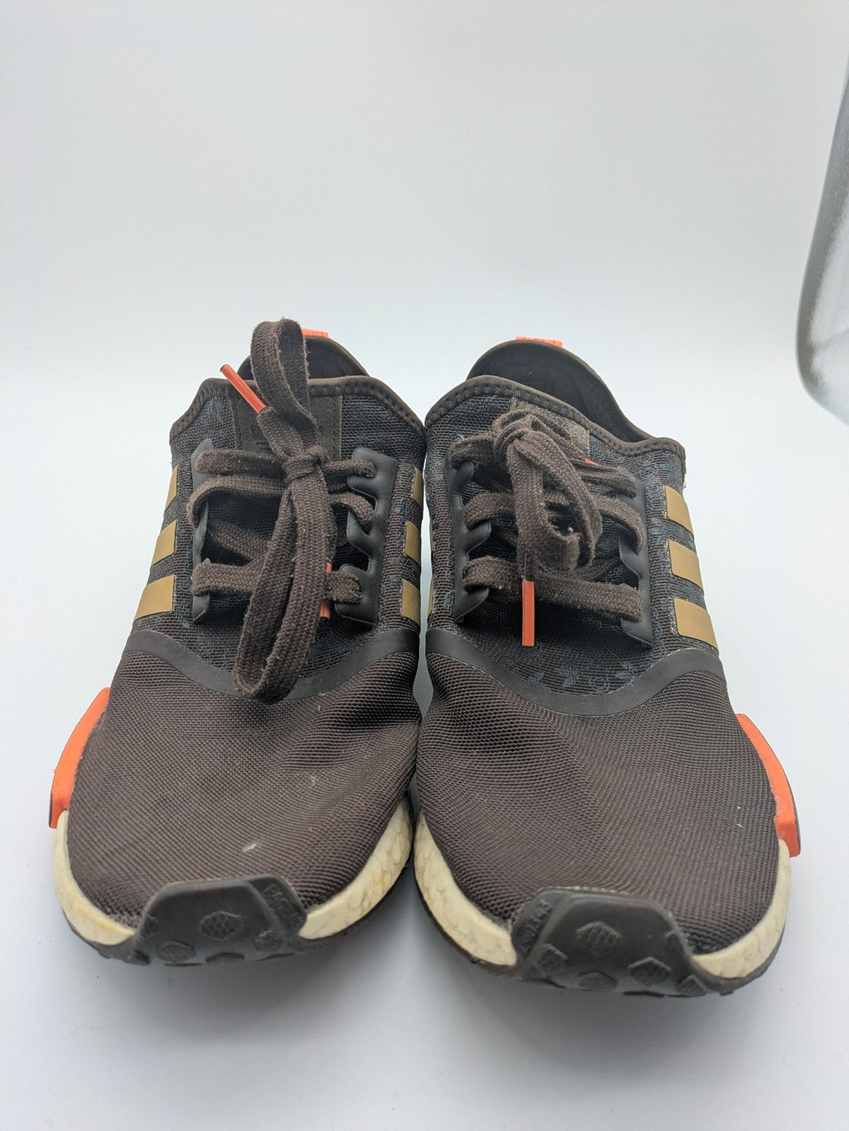 Adidas NMD R1 sneakers brown with tan stripes and bright orange accents, Boost sole.