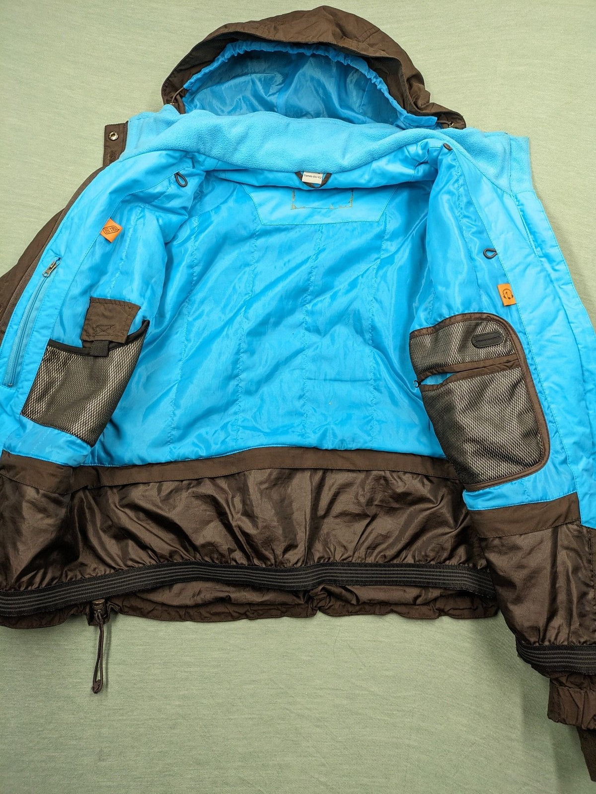 Thinsulate black and blue ski jumpsuit with hood and zippered pockets.