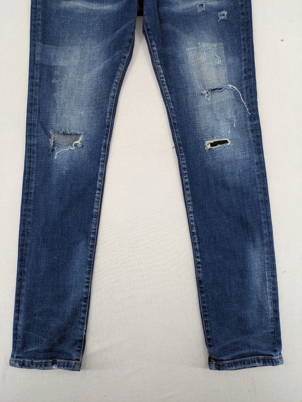 ICON 2 blue slim fit jeans distressed stretch denim with button fly and faded details.