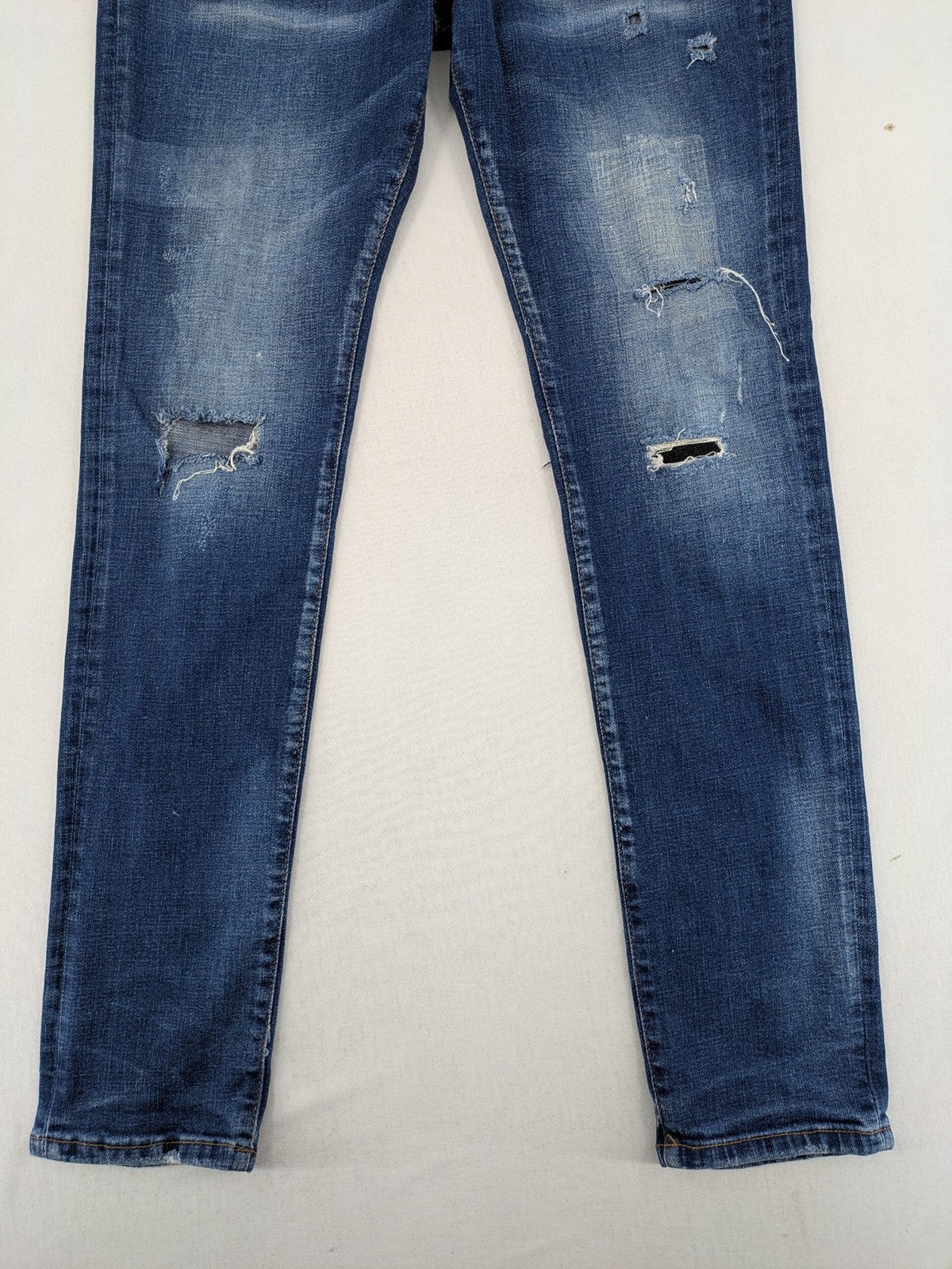 ICON 2 blue slim fit jeans distressed stretch denim with button fly and faded details.
