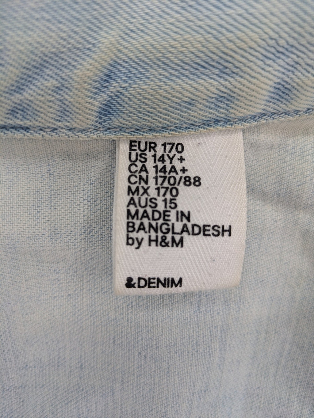 H&M denim jacket light blue classic trucker style with button placket and chest pockets.