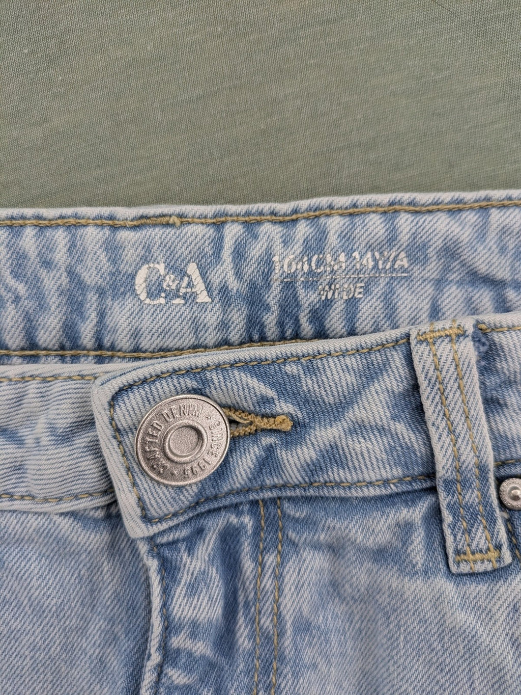 C&A blue wide leg jeans with distressed knee details and classic five-pocket design.
