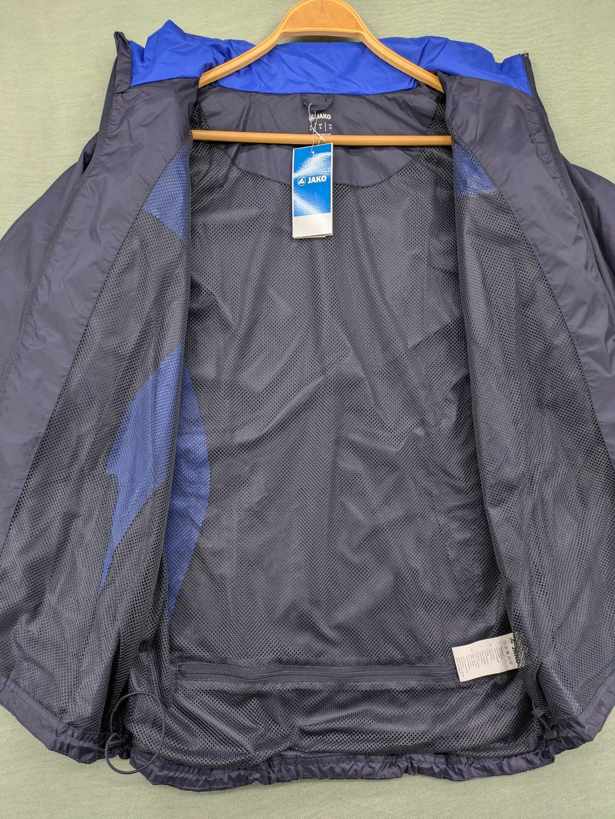 Jako navy windbreaker full zip jacket with breathable mesh lining and logo details.