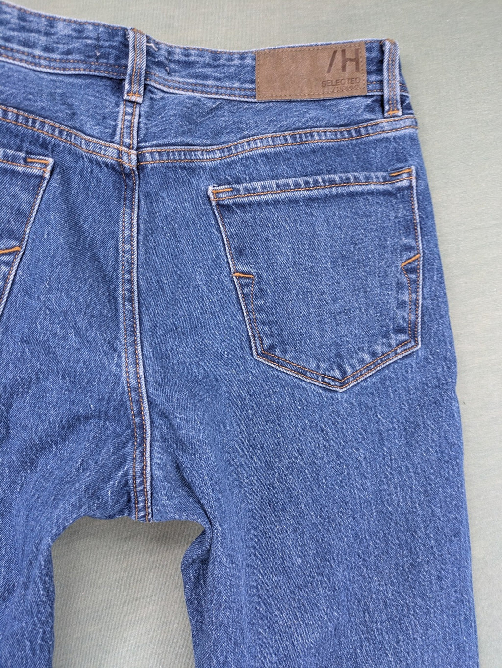 Selected Homme blue straight fit jeans with classic five-pocket design and medium wash denim.
