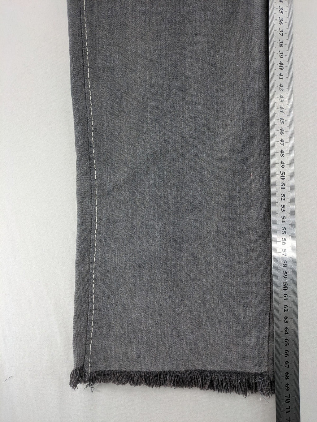 Jet Line grey straight jeans with embellished back pockets and frayed hem details.