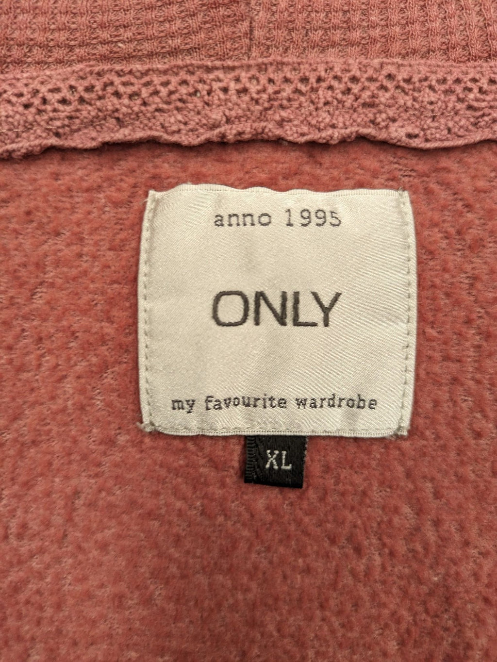 ONLY pink zip-through hoodie with hood, front zipper, and two pockets.